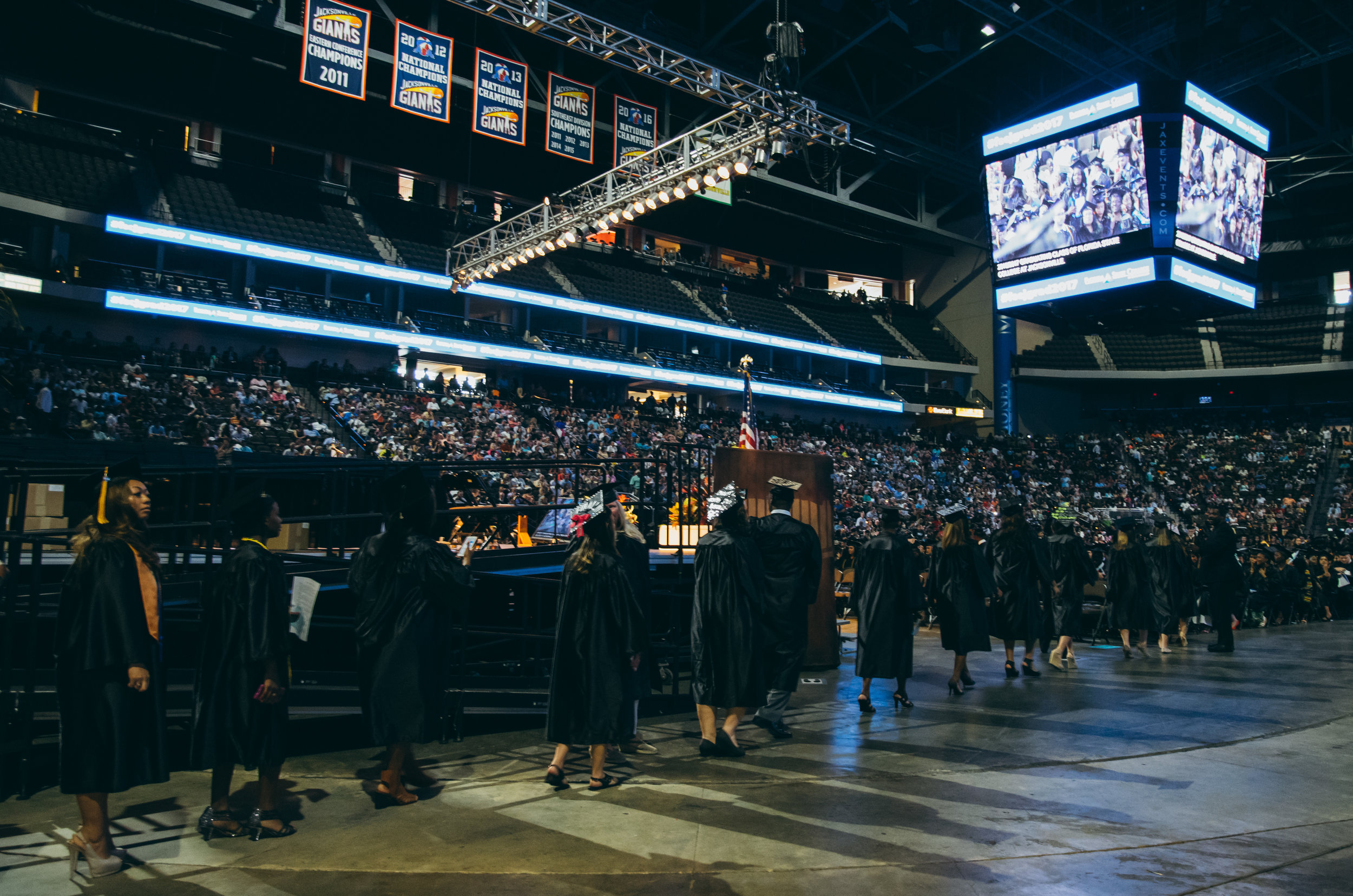As the graduates process in, Curtis and Robyn look for candid shots with Mark's direction.