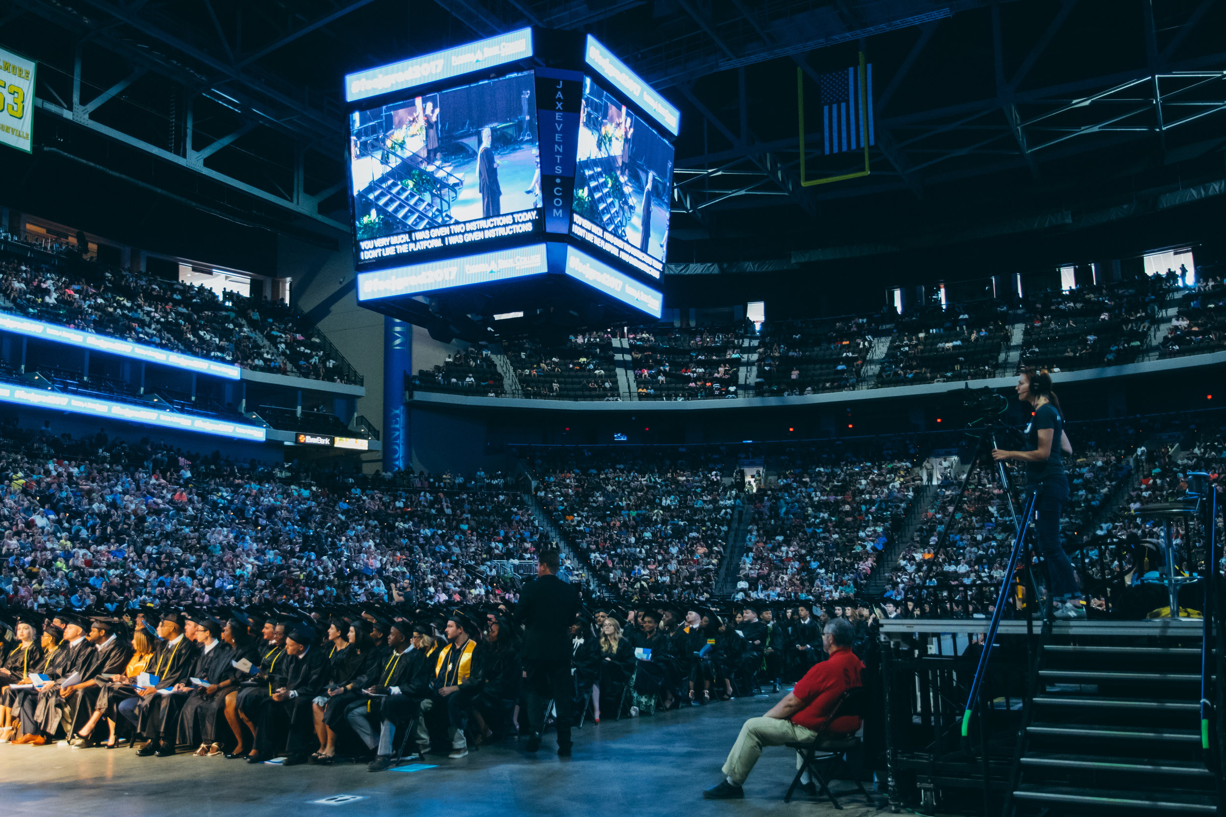 Robyn films a side shot of Commencement speaker Steve Piscitelli.