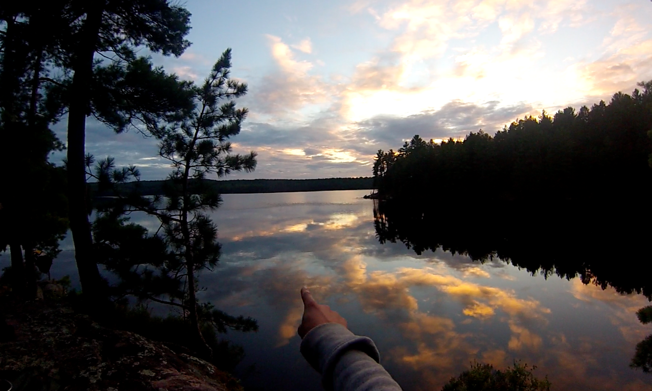 Algonquin - Tom Thompson Lake 2014 - pointing over the water at sunset.png