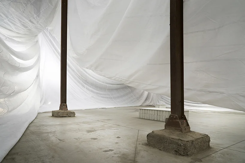 the tarp attached around the columns is creating a new space