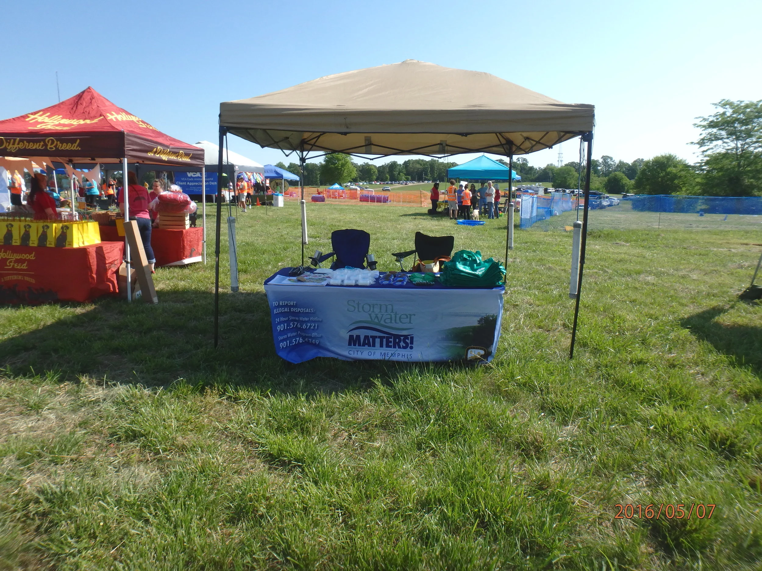 Our 2016 Dog-A-Roo booth. We provide many useful items to promote proper pick-up and disposal of pet waste, such as pet waste pick-up bag dispensers and Scoop-the-Poop yard signs. The bacteria in pet waste is a storm water contaminant.