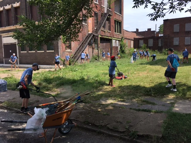 An AMP group from Texas works with residents to clean up a lot near Mission: St. Louis, 2017