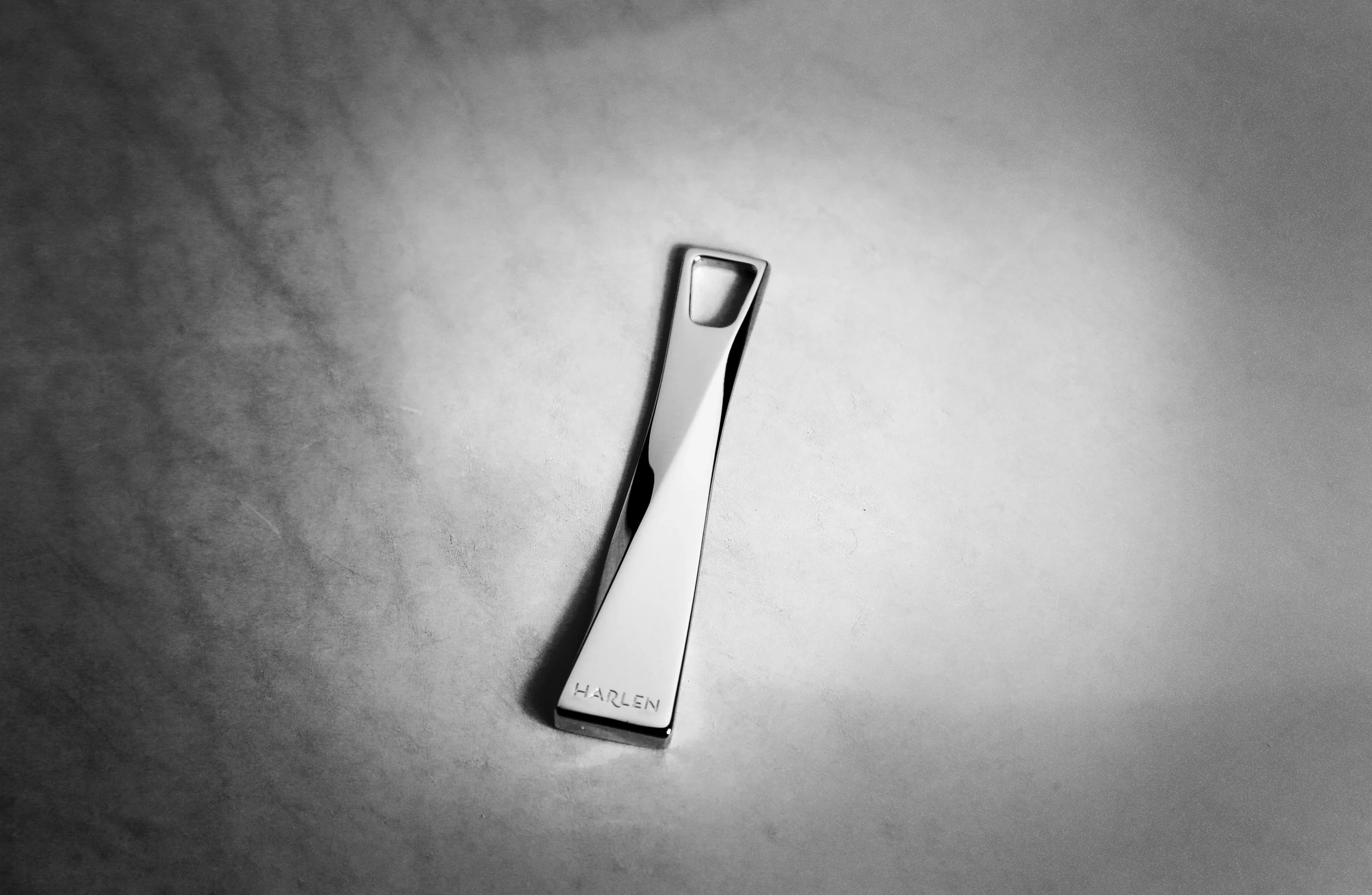 Custom hardware (zipper pull) design for luxury handbag brand. (Production piece in Palladium finish (photograph)