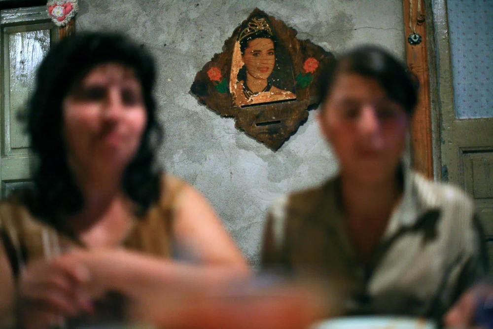 Picture with a woman wearing an Armenian national costume is hung on the wall in Garnik Arustamyan's house in Shushi.