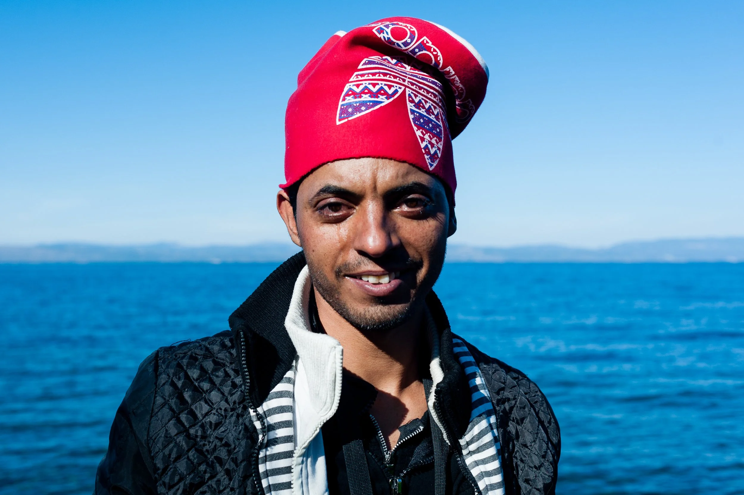 Conflicting emotions on the face of Ahmed, a Syrian refugee, as he reaches Lesbos after crossing from Turkey.