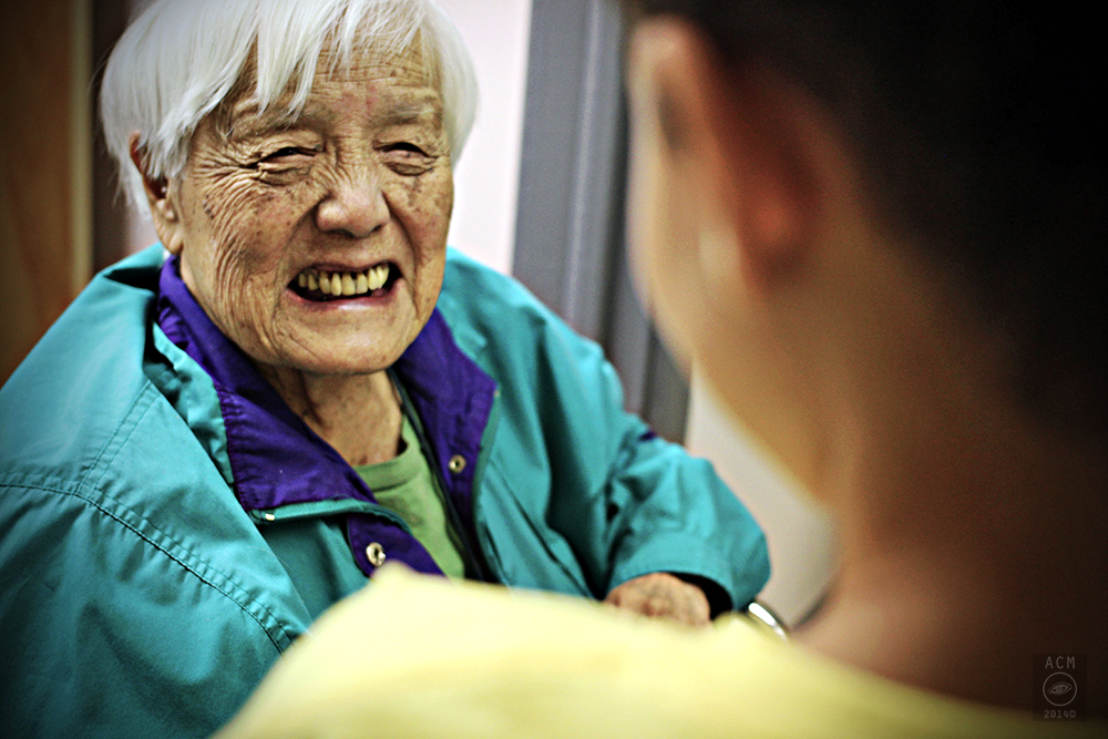   Grace Lee Boggs smiles at a Boggs school student on her name day.  