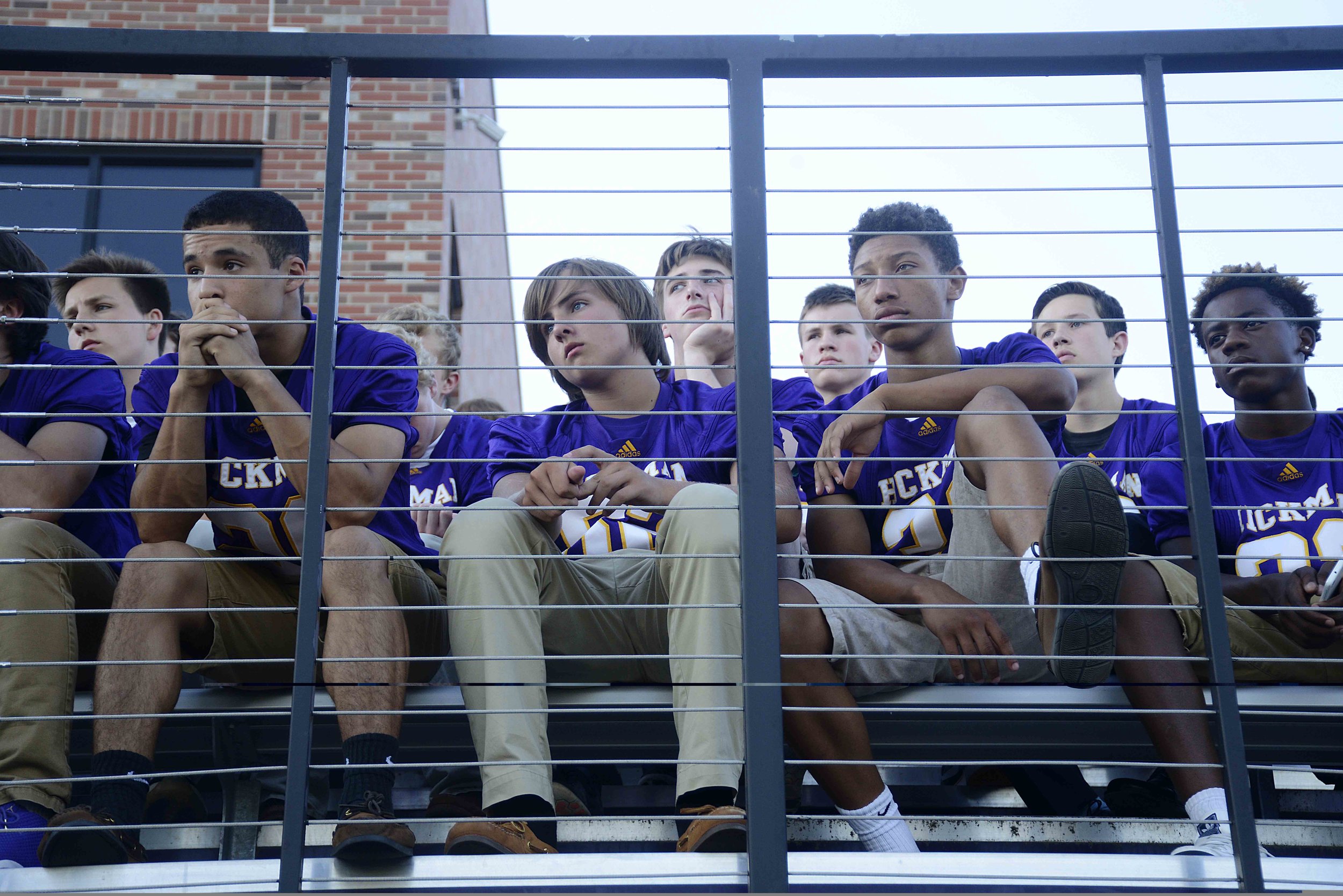  Members of the Hickman High School football team look towards the podium during the memorial service for their late coach Arnel Monroe at Alumni Stadium on Thursday, June 9, 2016. "I was raised in foster care. Coach let me know that this was my fami