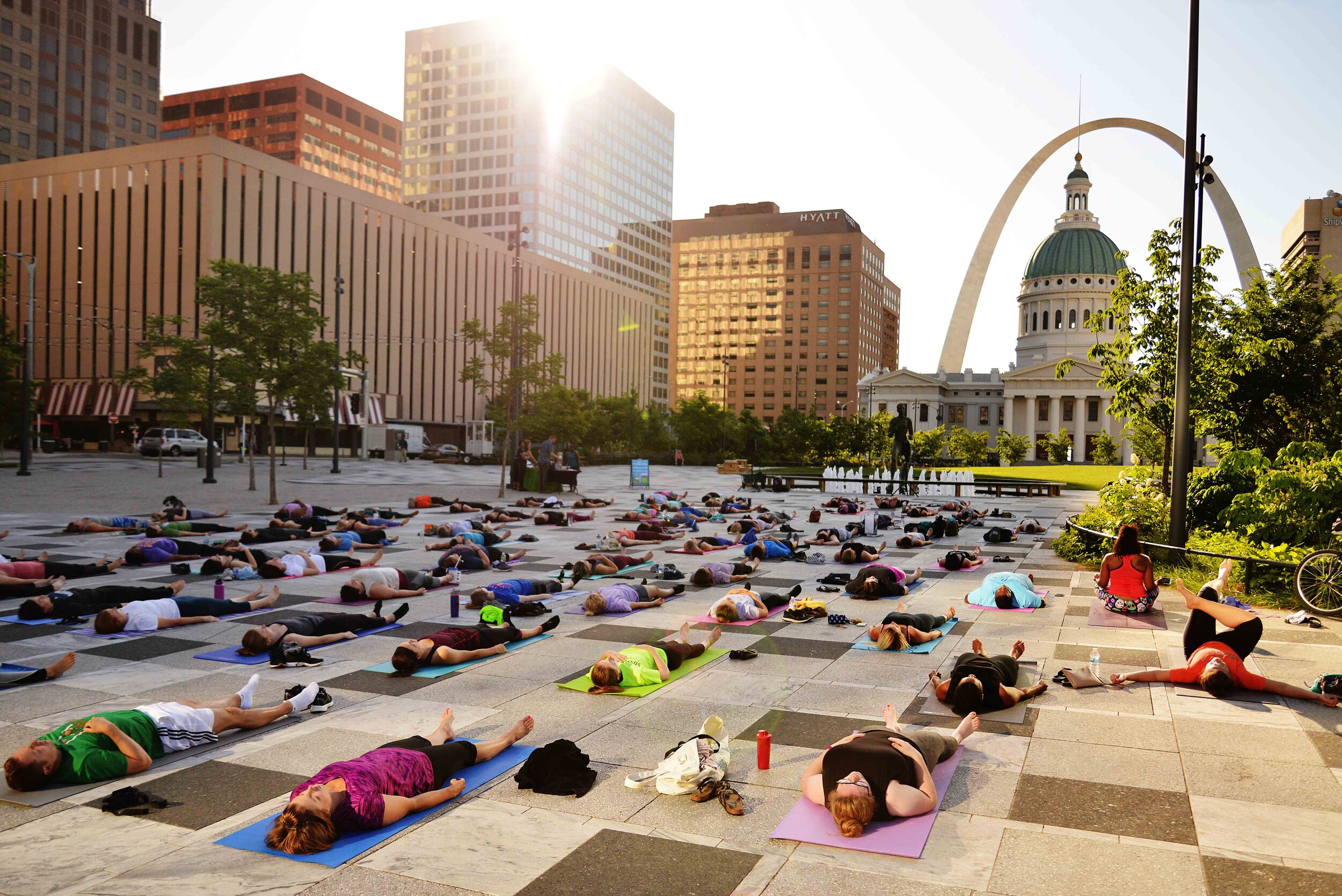  Practitioners wind down at the end of a yoga routine during sunrise in Kiener Plaza in St. Louis on June 5, 2018.  