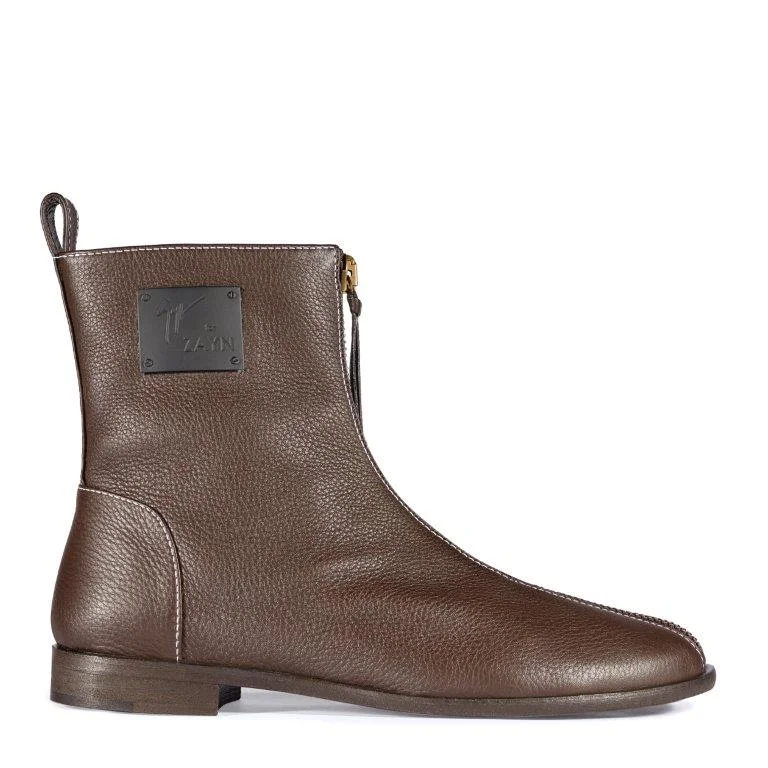 YASR: Featured in brown and black leather with contrast top stitching, an innovative, minimalist boot designed with a front zip that extends from the ankle down to the toe.