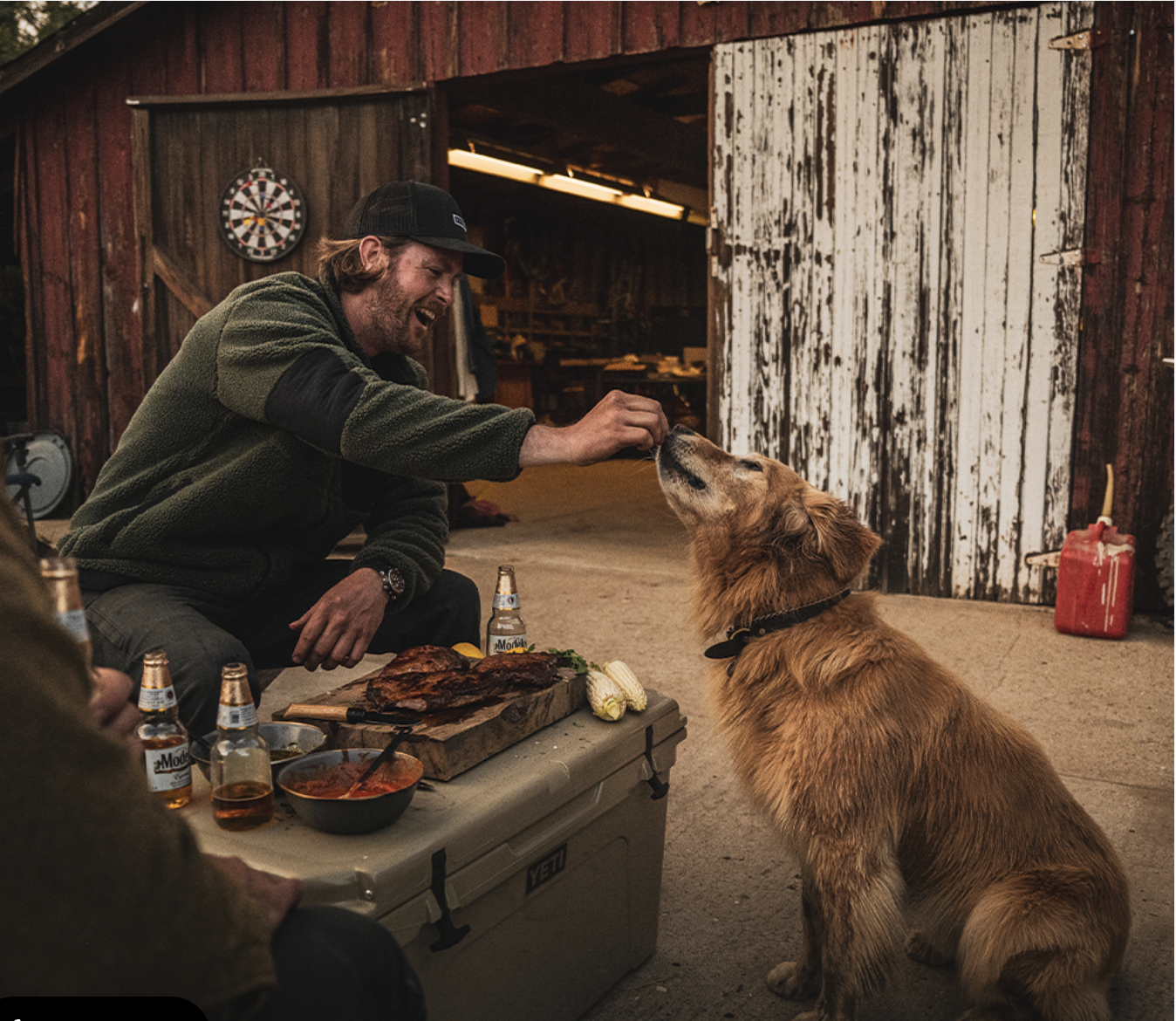  sitka gear man feeding dog steak rustic barn 
