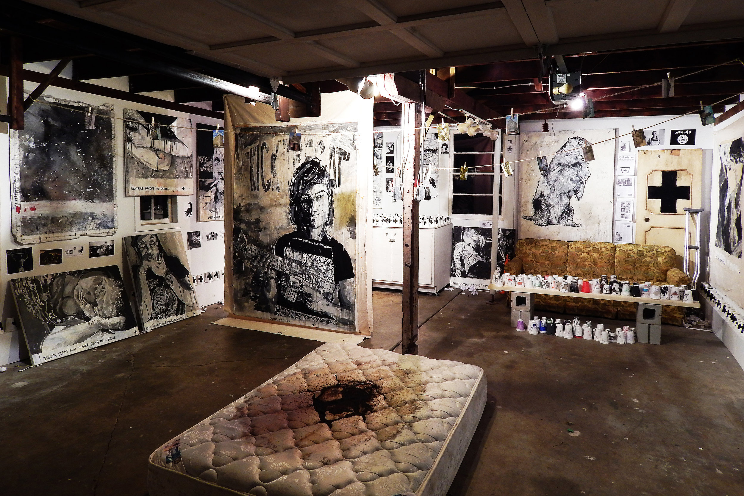 Kick the Cat (installation at Project 1612 in Peoria, Illinois) Acrylic, coffee, Sharpie and mixed-media on canvas with cups, mattress, found objects, post-cards, etc. (2015)