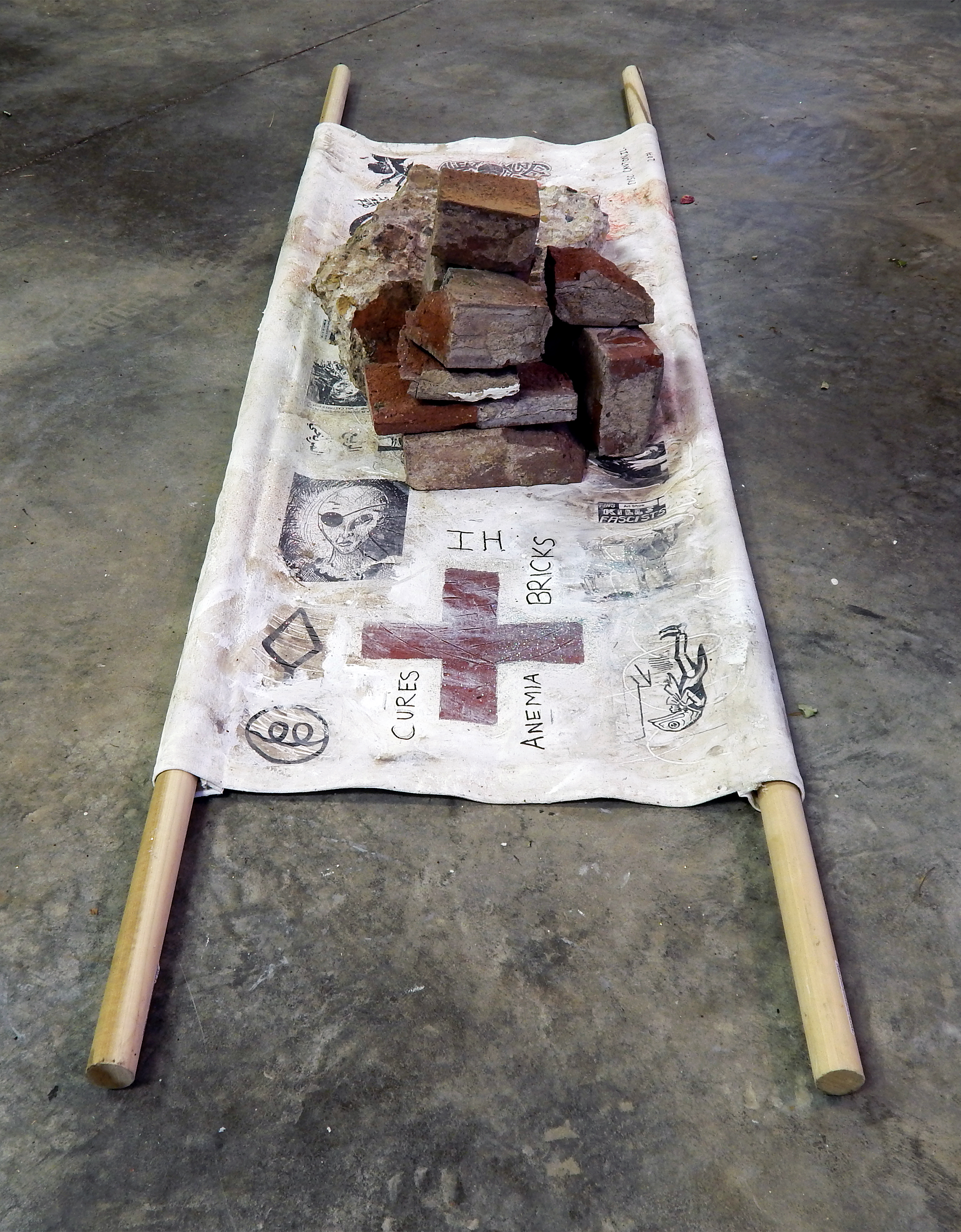 The Healing Properties of Post-Industrial Debris: IH Bricks (The Barista Who Could See the Future) Acrylic, coffee, glitter ash, stickers, wig-hair, Sharpie on canvas with bricks from the abandoned International Harvester plant in Canton, Illinois and wood (2017).