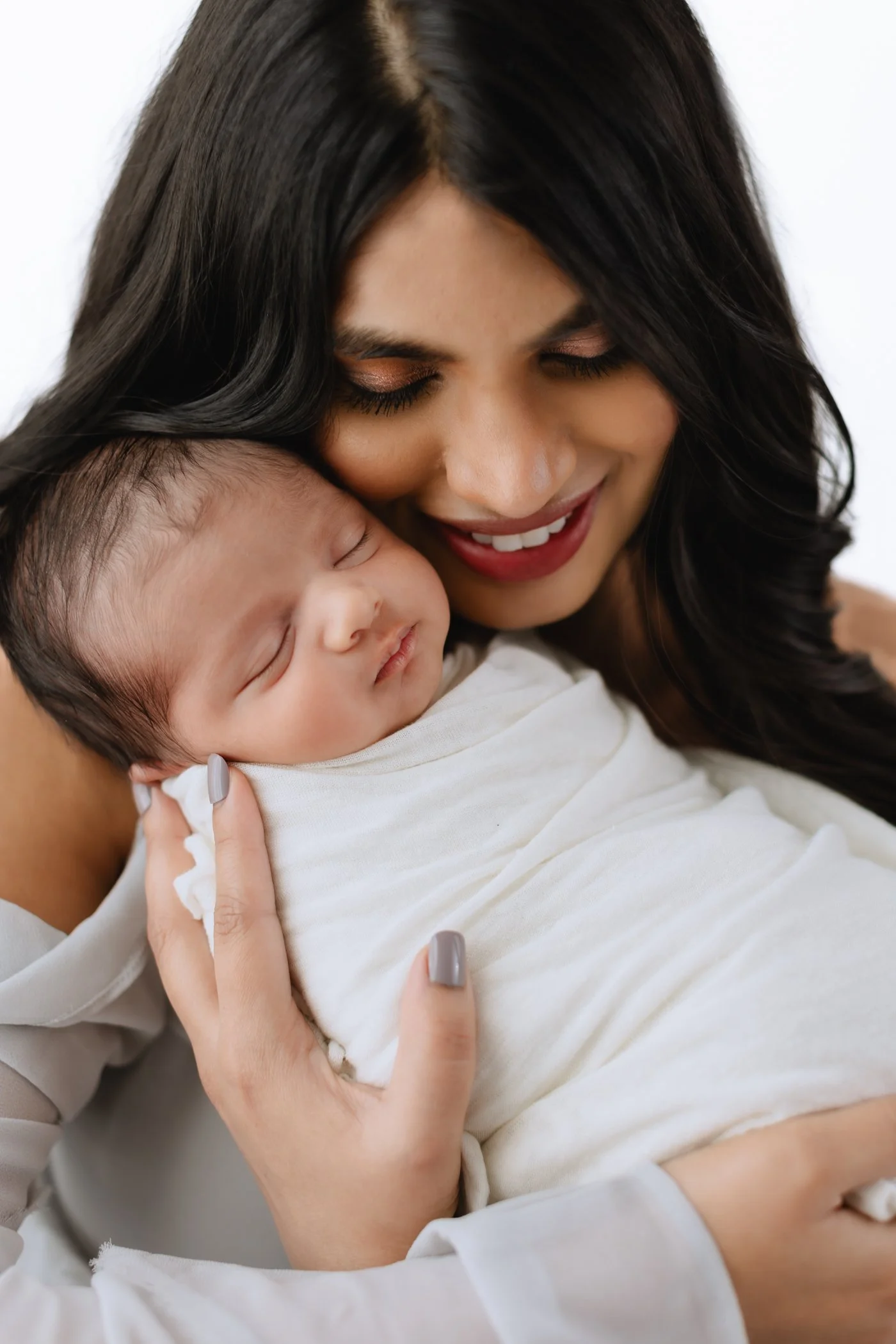 Heirloom newborn portrait – Virginia Beach mom holding baby during studio session.