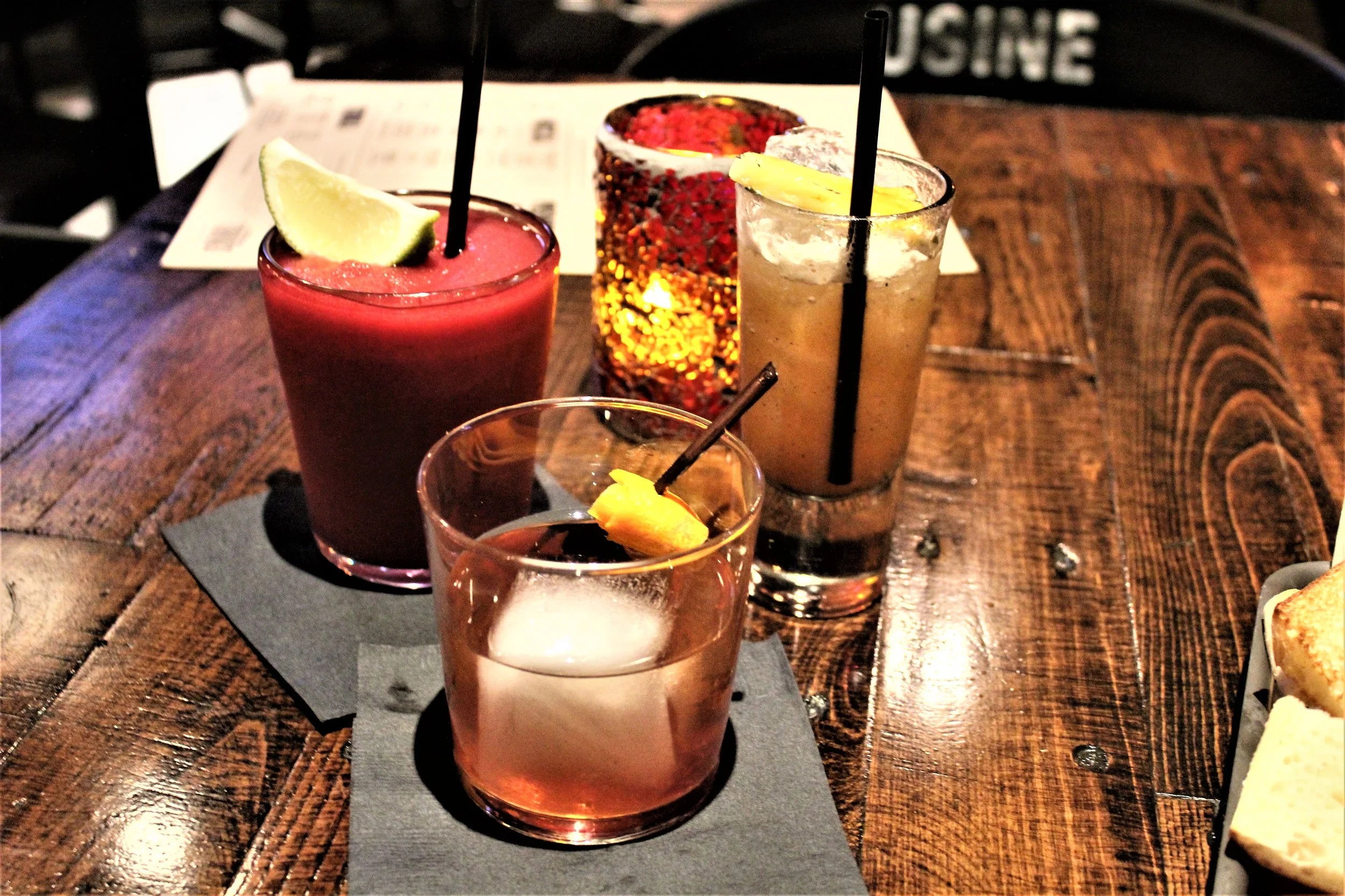 Far left The Stinky Inky-This is a smokey yet fruity drink. You will either love or hate the smokey after taste in this one. It definitely gives you that stinky inky feeling, but it is worth experiencing at least once. Far left The Dirty Sanchez-This drink features pineapple and lime. It is topped with a sugared pineapple slice that is AMAZING! Front center the Flux-This drink is like an old fashion and features angostura bitters and simple syrup.