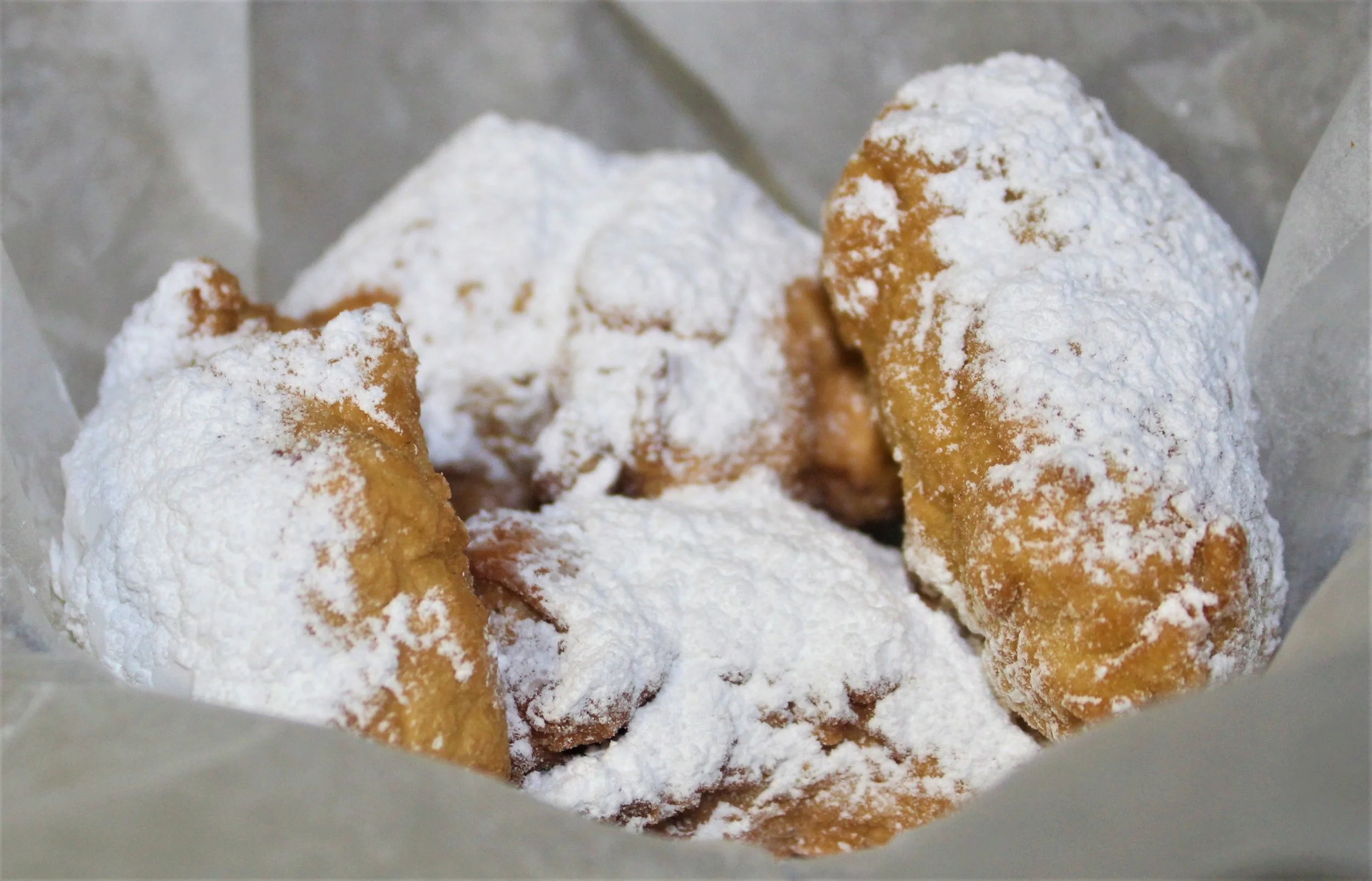 Beignets covered with powdered sugar.
