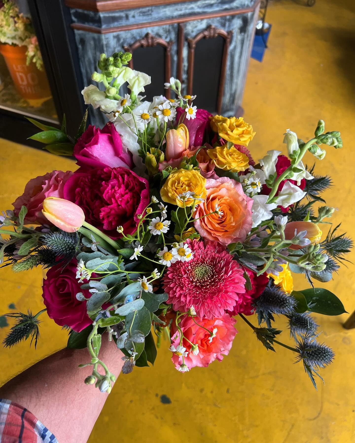 This weekend&rsquo;s Bridal bouquet. Featuring hydrangeas, free spirit roses, hot pink peonies, hot topaz roses, blue thistle, peach tulips, yellow spray roses, snapdragons #arborhousefloral #neworleansweddings #brightbridalbouquet #floristnearme #ne