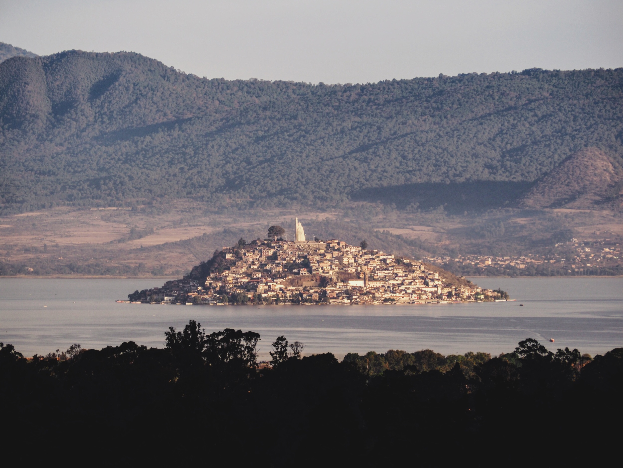 View of Isla de Janitzio from our adobe casita Pátzcuaro, with the giant statue of José María Morelos at the top