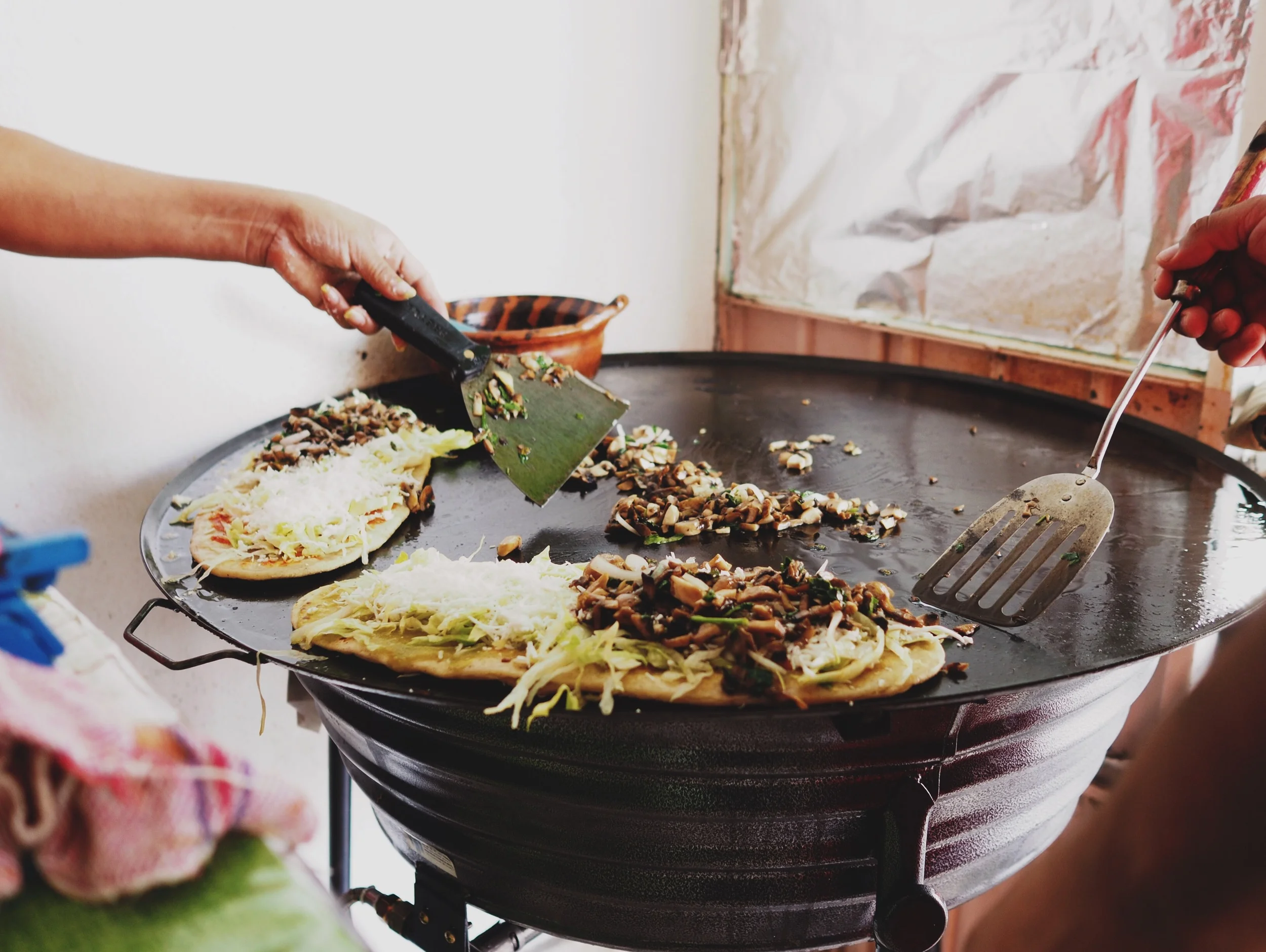 Huaraches – a thick corn tortilla stuffed with beans and grilled, with mushrooms, salsa, cilantro & lettuce for garnish.