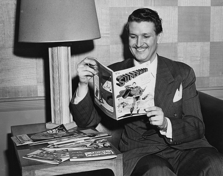 Bud Collyer, Superman’s voice on radio and animation, feigns a look of interest in his counterpart’s four-color adventures.