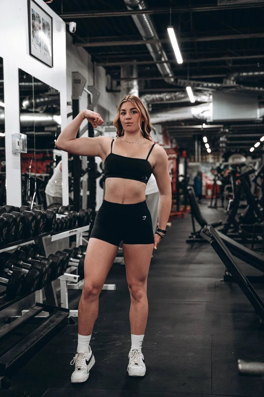 Tanya, Brickhouse Gym personal trainer, standing beside the dumbbells at the gym.