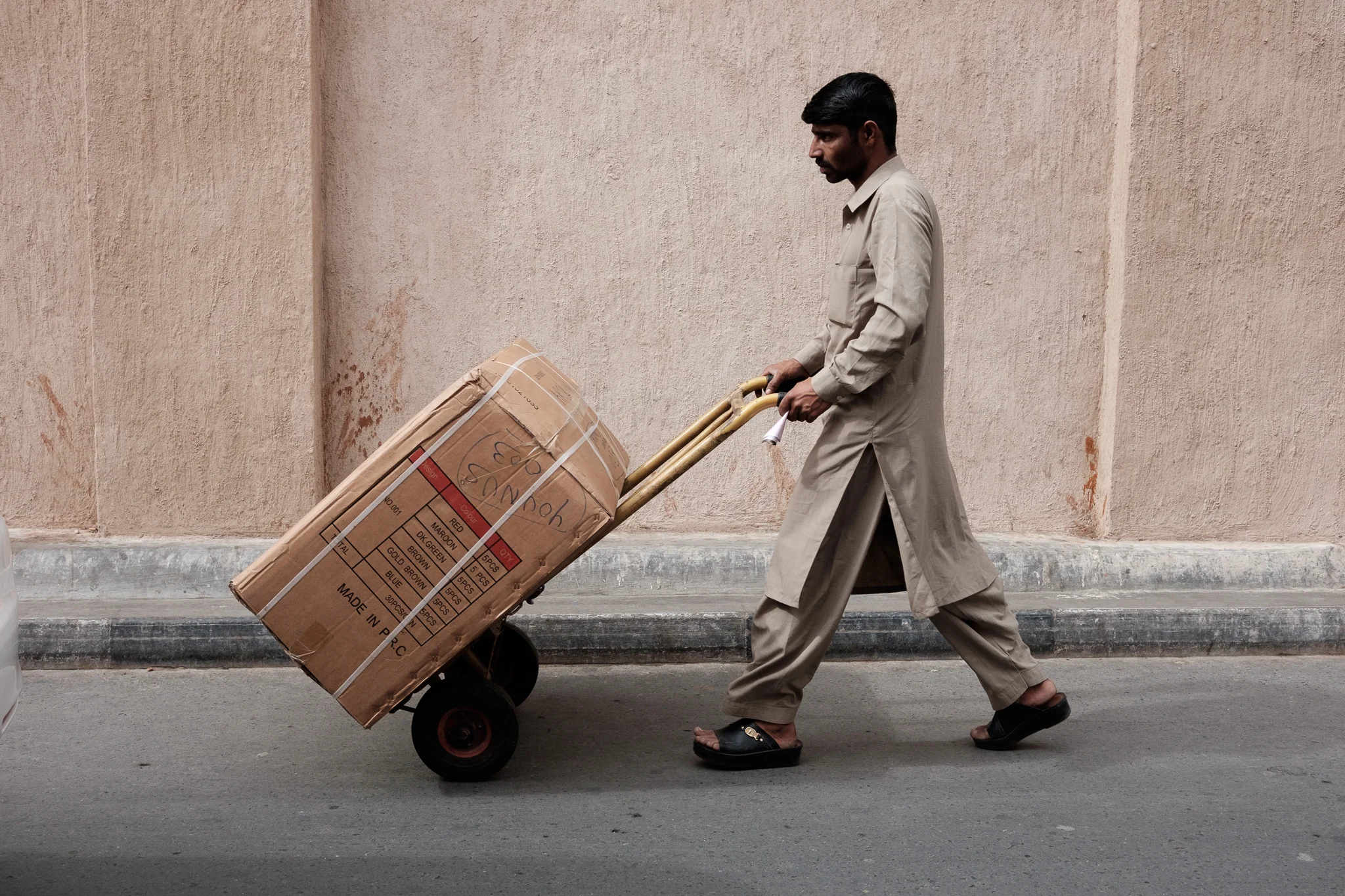 You see many men like this one constantly shuffling goods in the area with a cart.