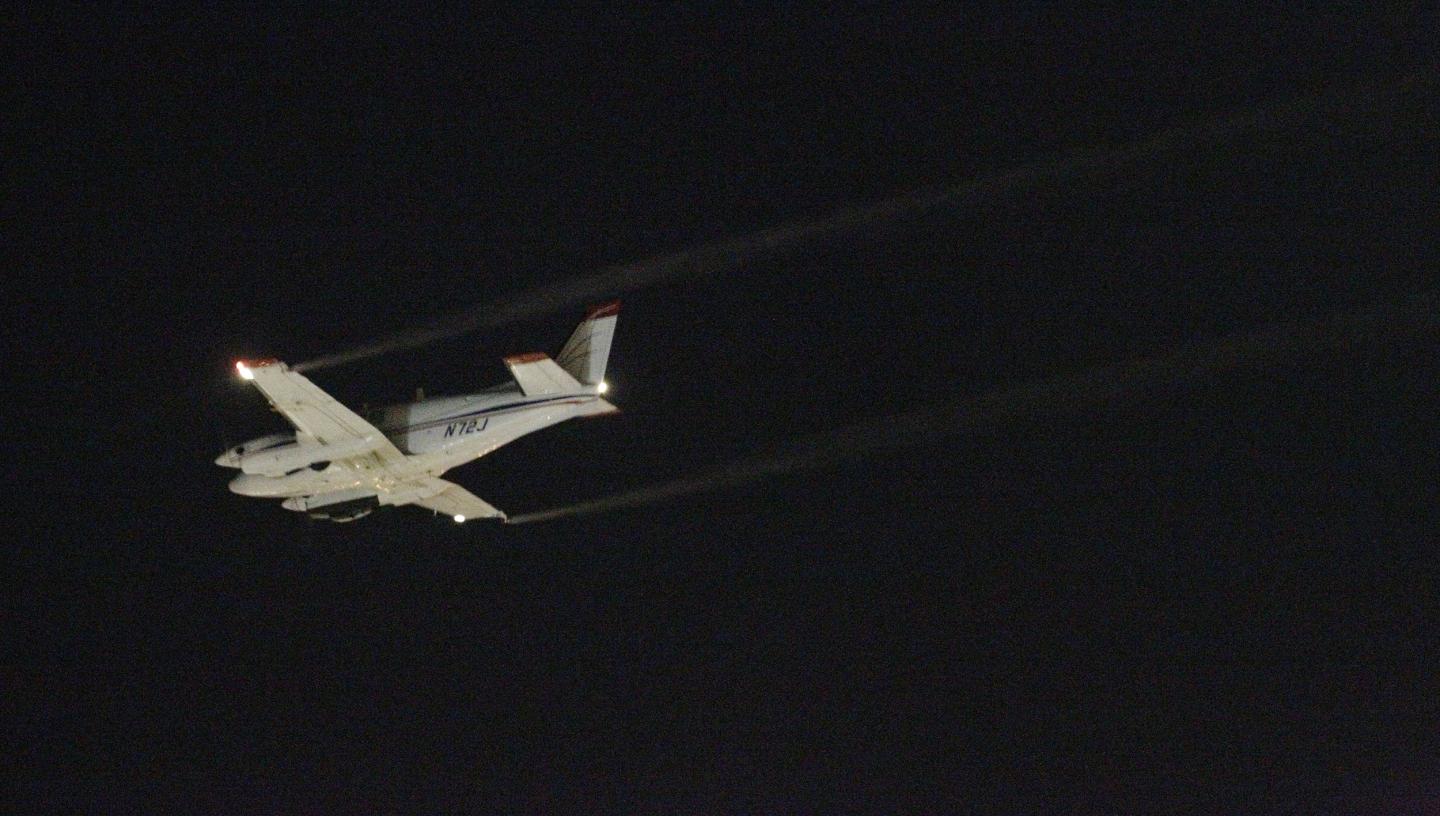 A Beechcraft airplane sprays an insecticide over Dallas to curb the spread of West Nile virus on August 20, 2012. LM OTERO/AP