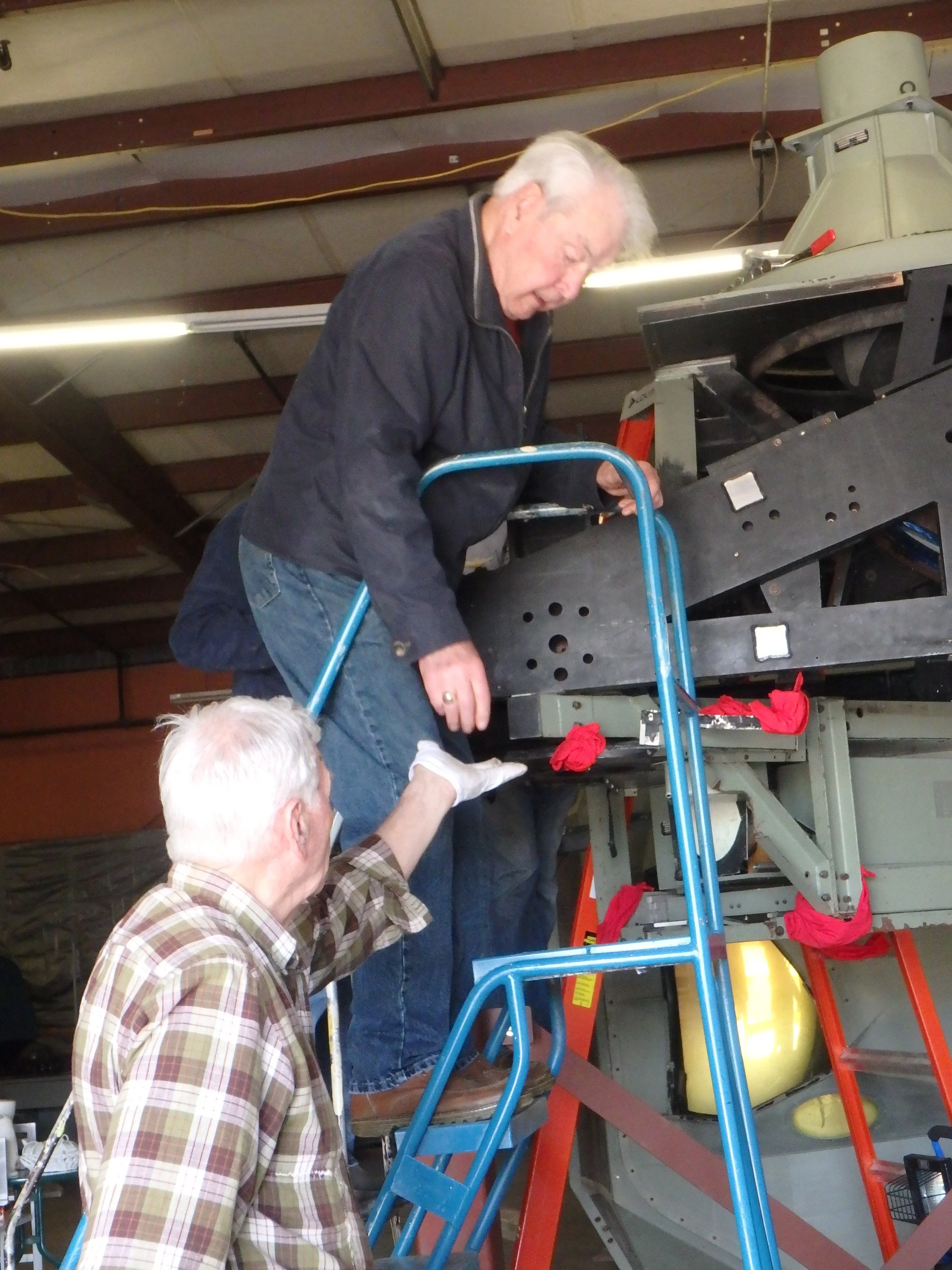 Gene Abbey hands frame hardware to John Lash