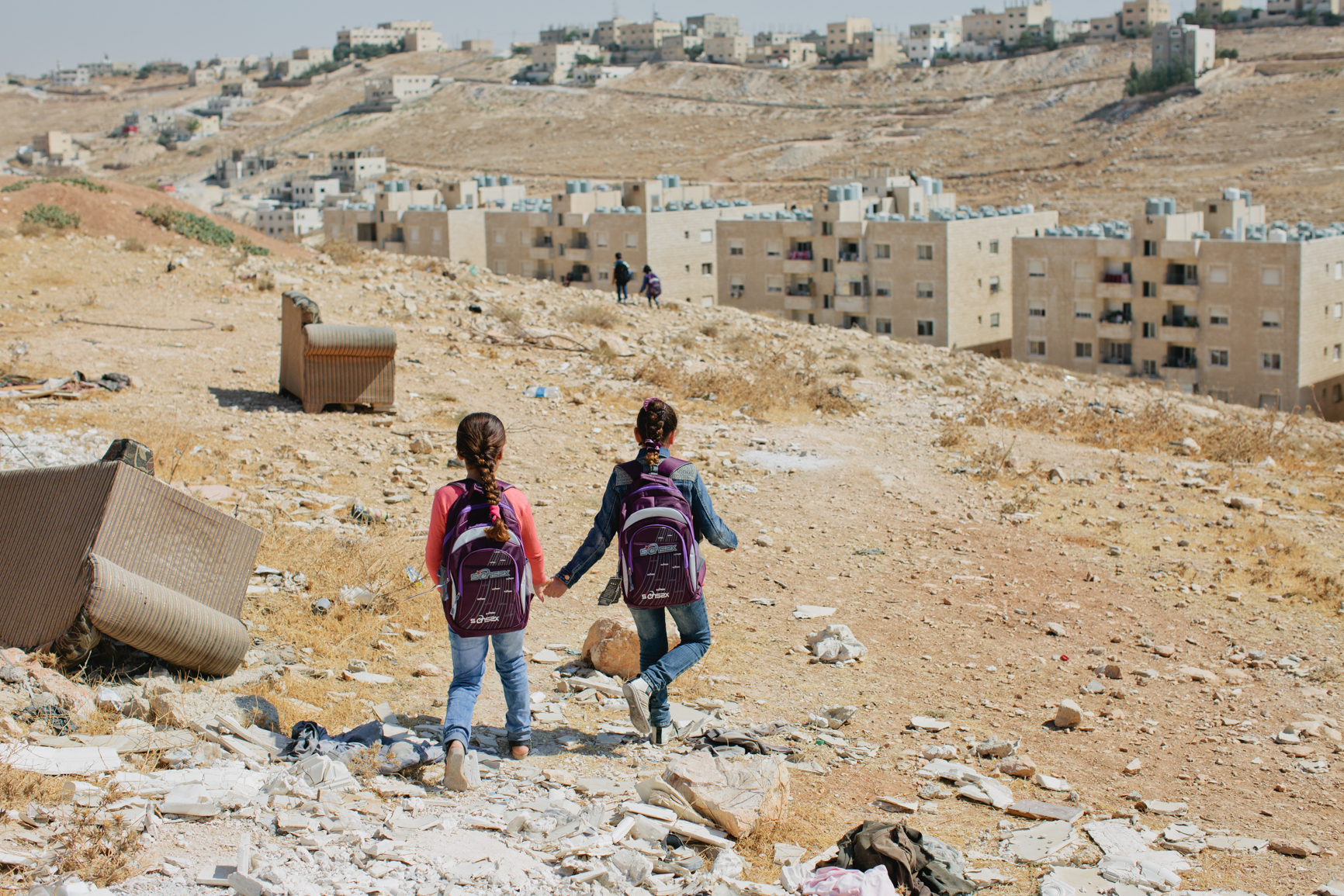 Two Syrian orphans return from school in Amman, Jordan. UN-registered urban refugees’ children may attend local schools. The government has divided the schools in two, Jordanian children attend school in the morning and Syrian children go in the afternoon. Some Syrian children are up to four years behind on their schooling.