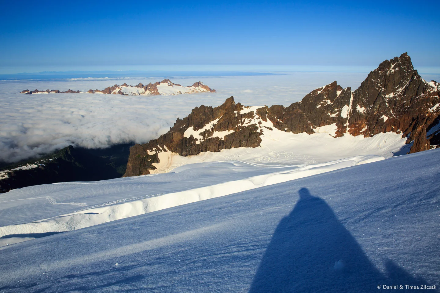 Climbing Mt Baker - Taking a break above a large crevasse