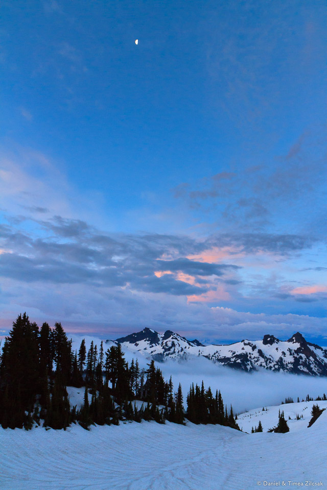 Moon over Tatoosh Range before sunrise. Clouds over Paradise and the lower mountain, Mount Rainier National Park