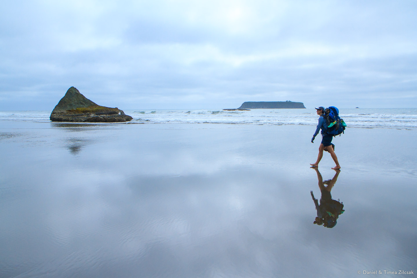 Beach hiking along South Coast Wilderness Trail, Alexander Island at the horizon