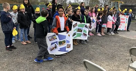 Elementary students took part in the groundbreaking ceremony for the new James L. Mulcahey Elementary School by holding signs and leading the Pledge of Allegiance. Taunton Gazette photo by Charles Winokoor