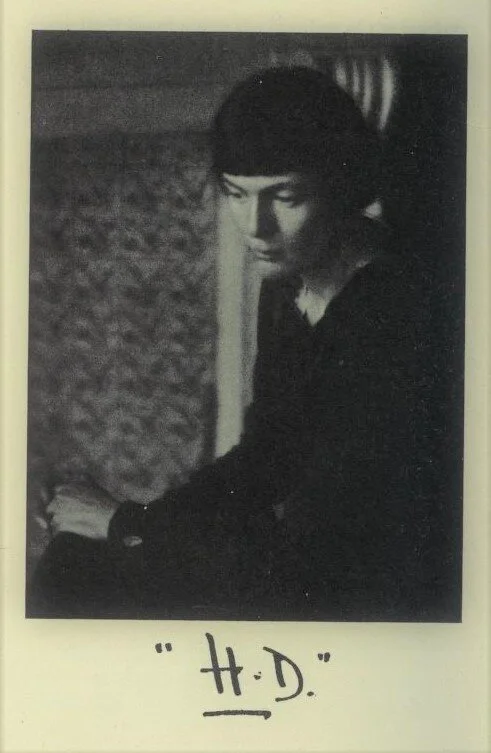 Photographic portrait of Hilda Doolittle, signed “H.D.” from  Tendencies in Modern American Poetry  by Amy Lowell. Public Domain.