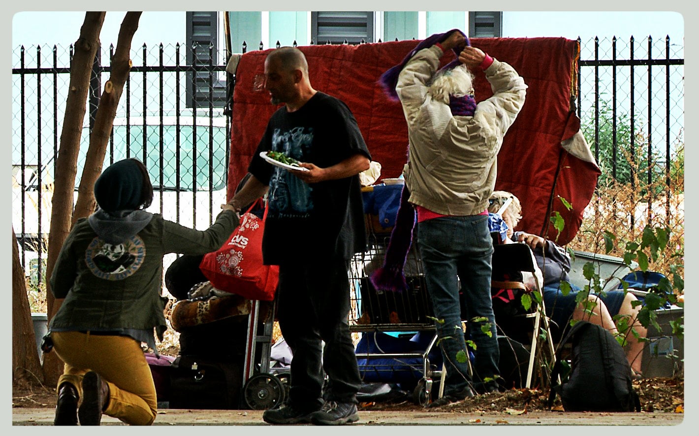 Activists reach out with healthy food and conversation at a now fenced-off former tent city in Reno.