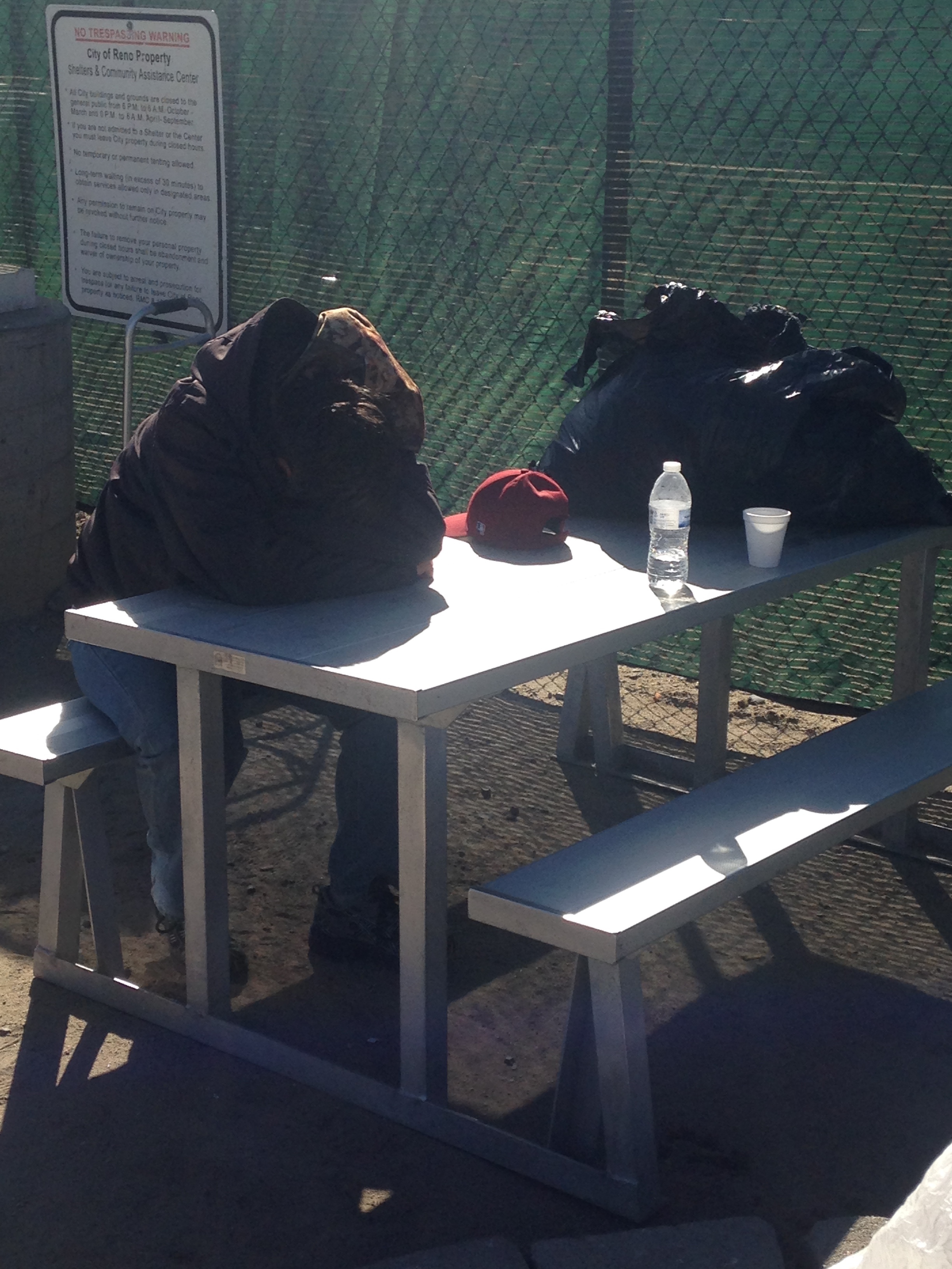 Many homeless who sleep at the Mission stay in its courtyard all day, waiting for the next meal and a warm bed at night. Photo by Pierce Baker.