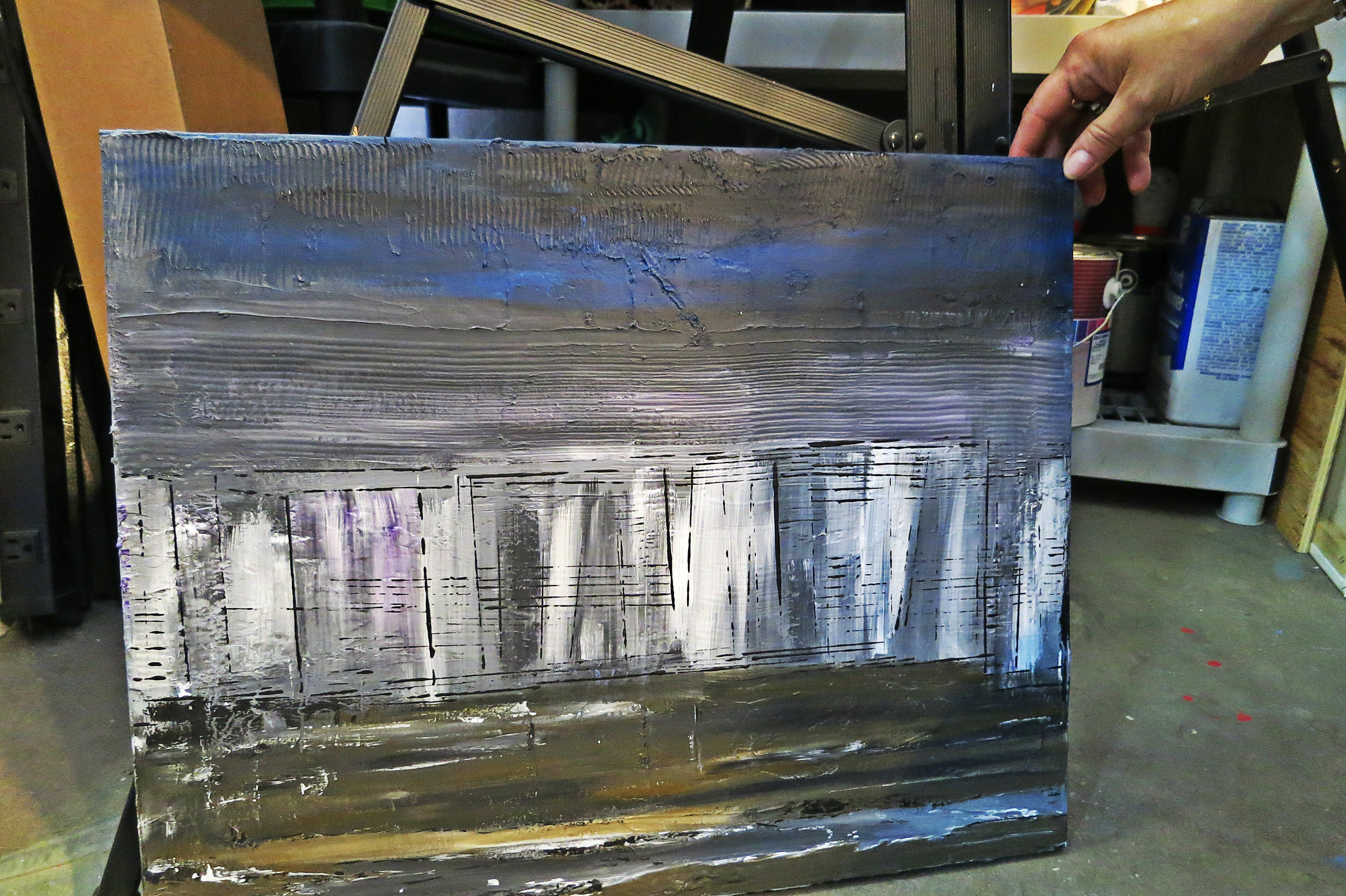  Another work in progress: “I have an idea here with charcoal ash, I want to create smog. But then down here, I want to create some daisies. It doesn’t matter how dark, or gloomy or smoggy it is; there’s a light, there’s hope, there’s a ray of sunshine.”