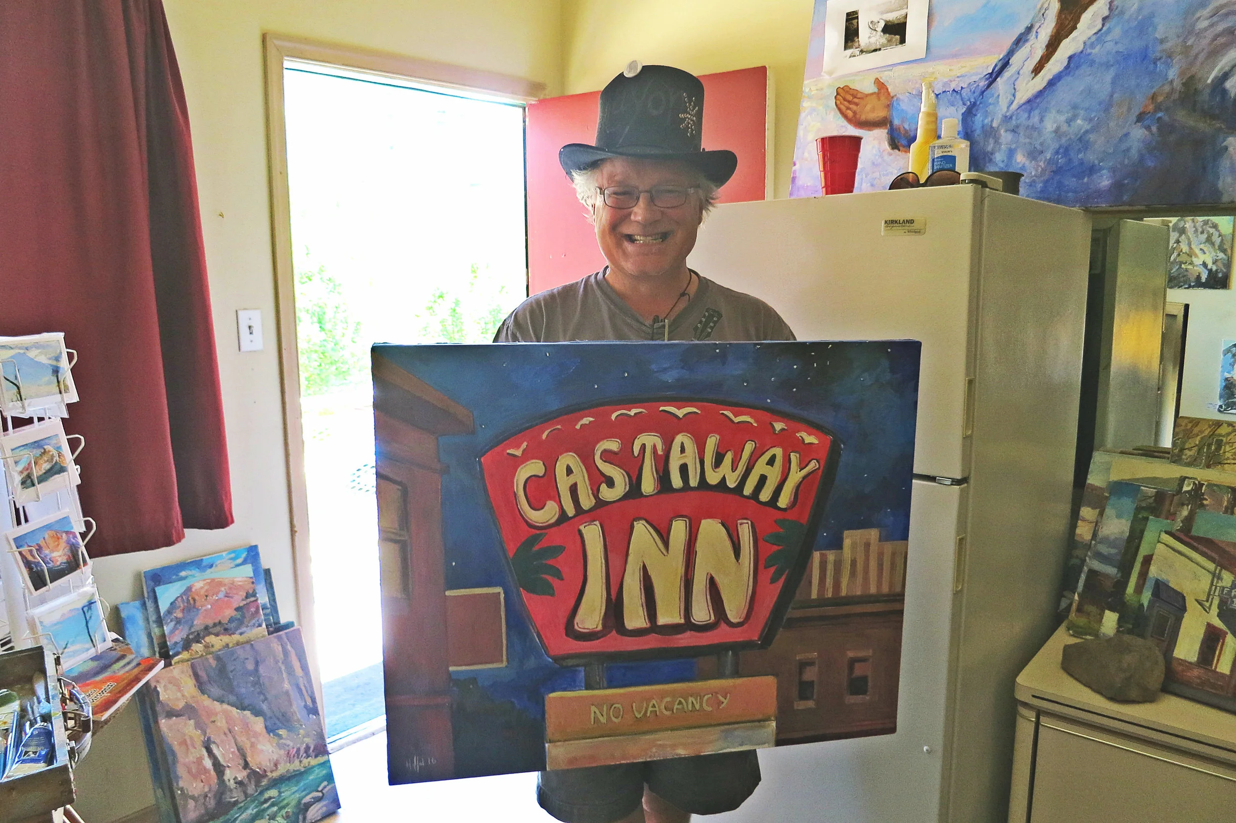 Erik Holland, with one of his works in progress, the sign of the Castaway Inn motel, which faces possible demolition as part of a huge project to redevelop downtown Reno.