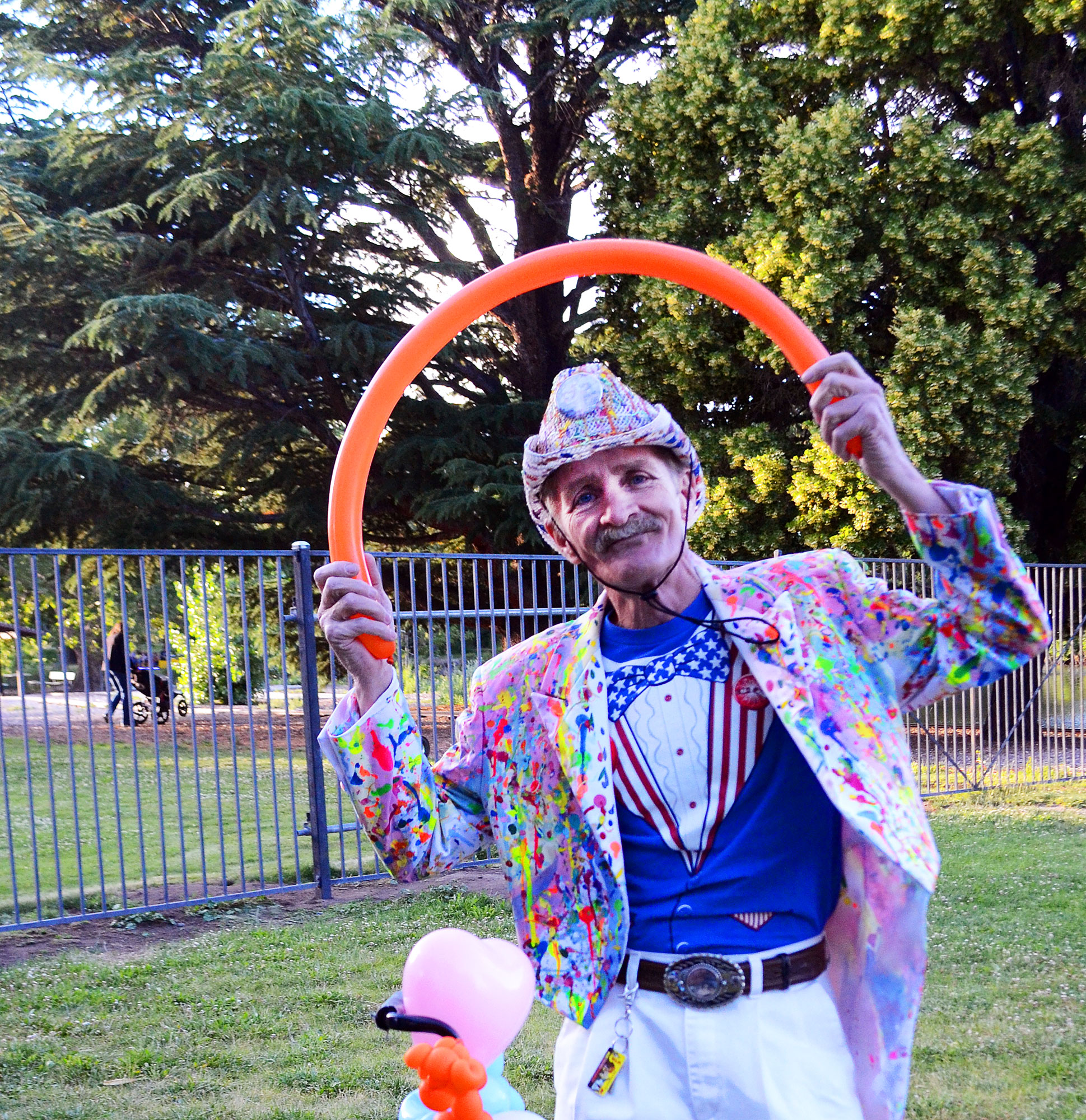 Local balloon artist, I.B. Funny, poses for a picture while making balloon creations for kids at Idlewild Park. “This is a classic pose that I like,” he says as he gets into position with a smile on his face. I.B. Funny frequents local events to share his craft of balloon making. 