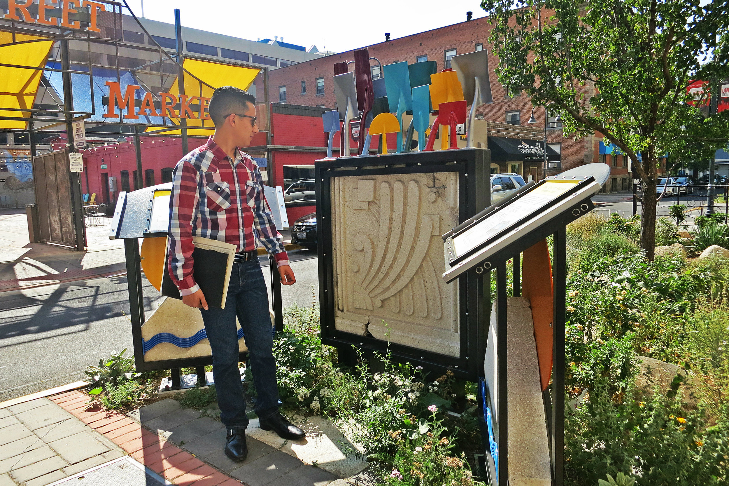 Hagen stands next to a small tribute to old buildings on West Street, which includes a broken terra cotta tile salvaged from the Mapes. “I think it’s awesome. I wish it was closer. It would have been cool if they would have incorporated this into the new downtown plaza where the Mapes used to be."