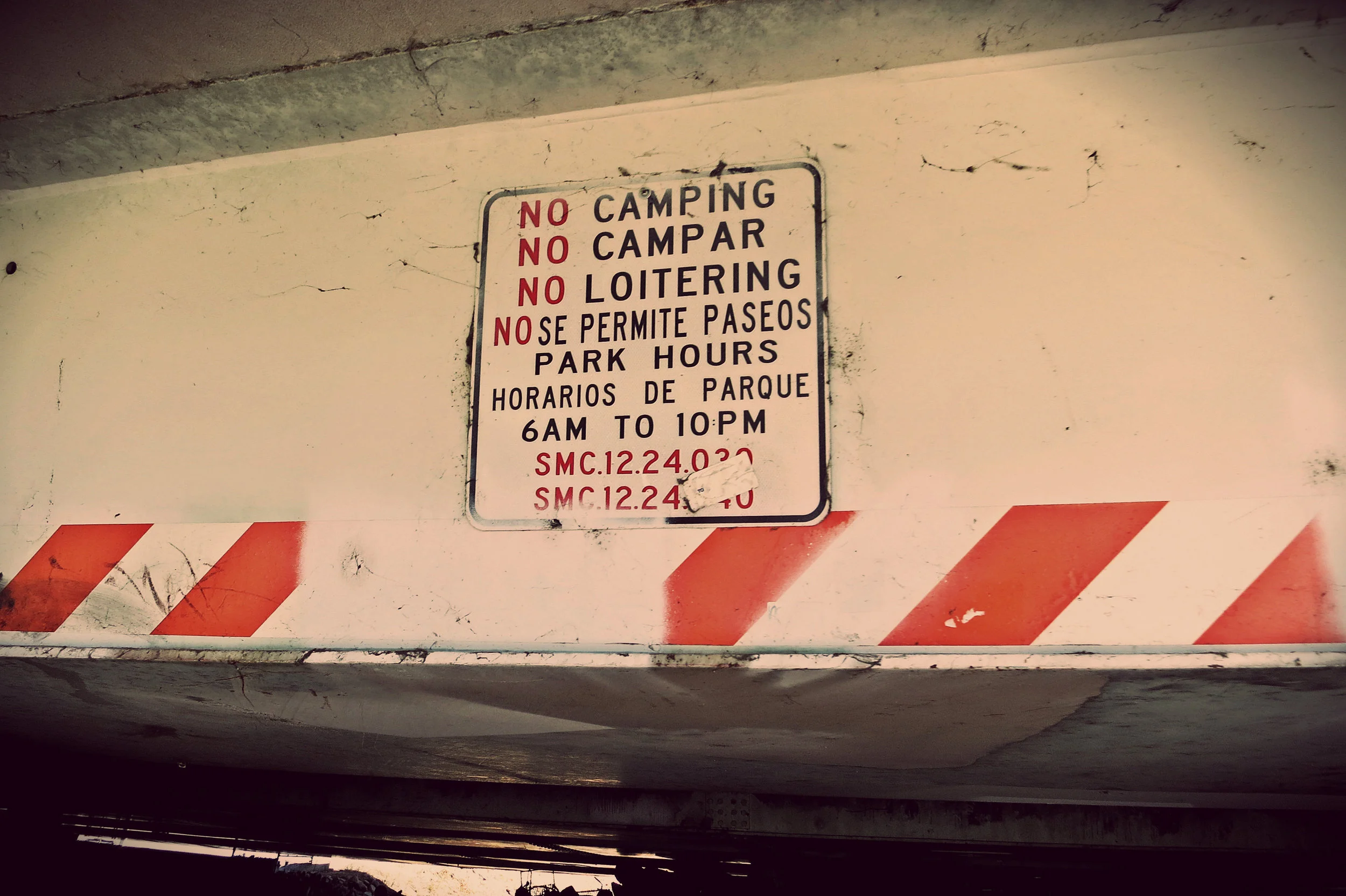 This sign on an overpass to the river path makes people camping there, out of necessity, fear every day they might be kicked out.