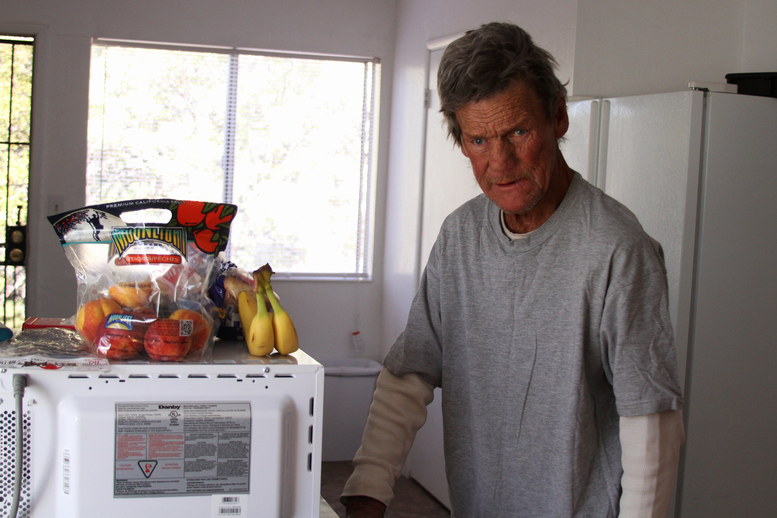Doug gets to use a shared kitchen with housemates in downtown Reno, after being homeless on a porch.
