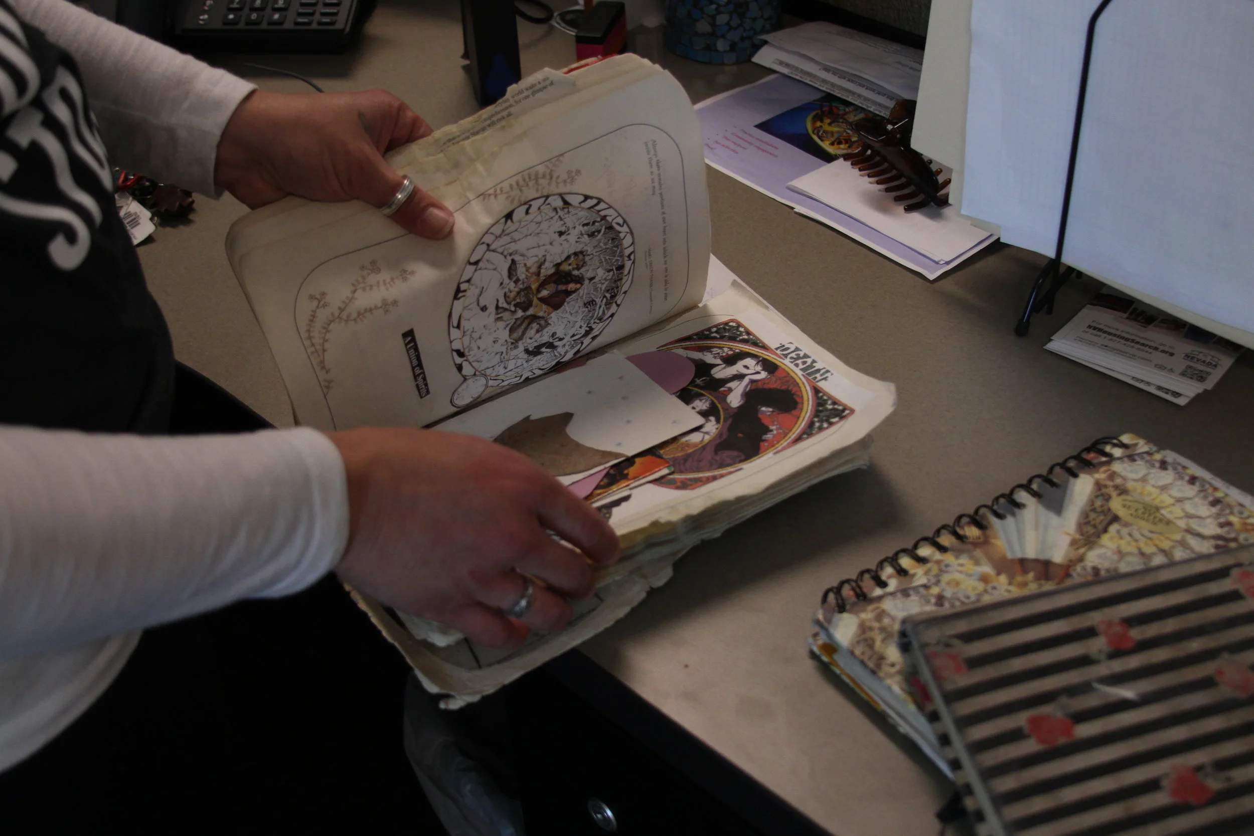 Lisa Lee looks through the notebooks she created when she was homeless. Photo by Jose Olivares for Our Town Reno.