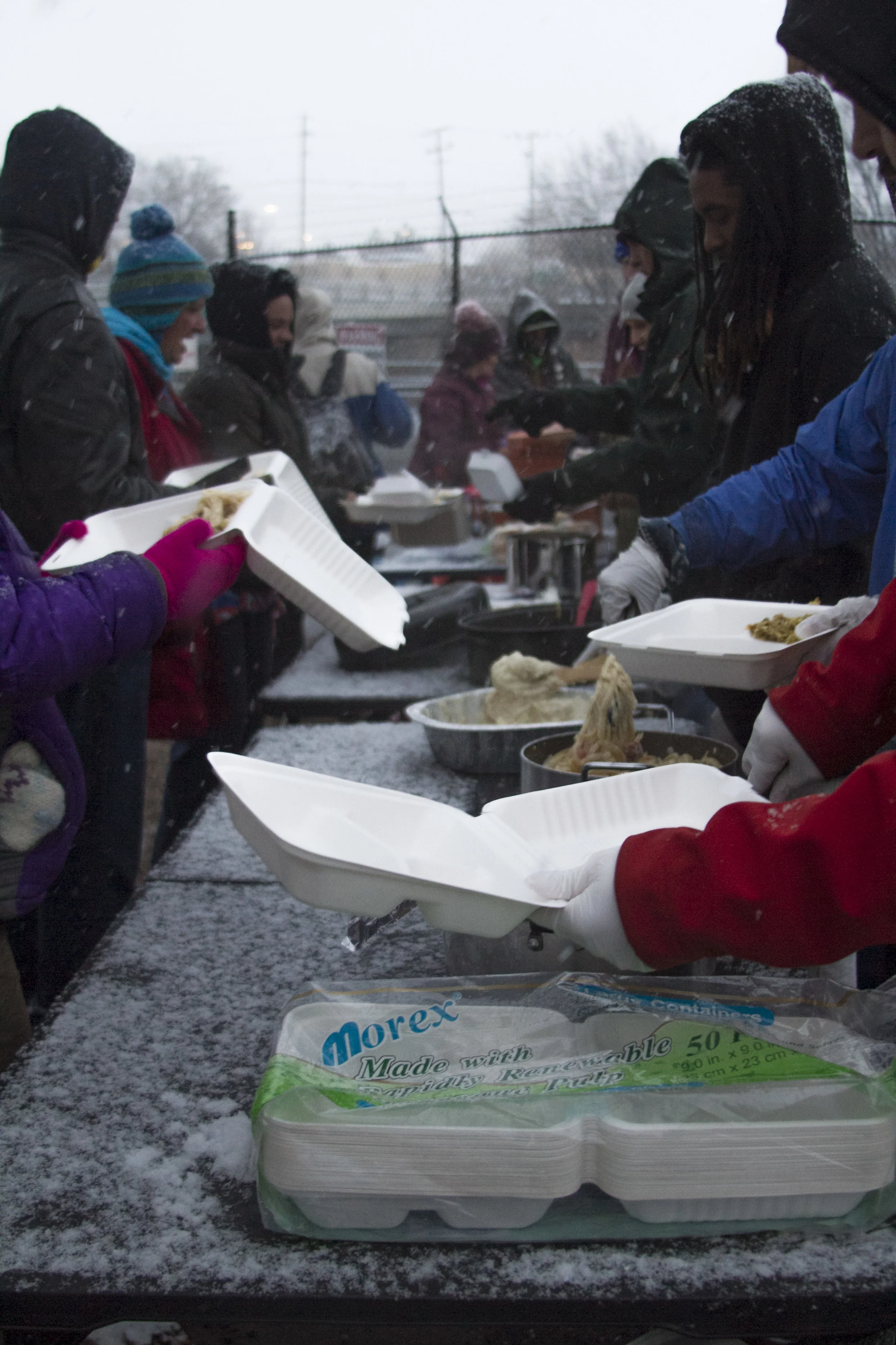 For over an hour people in need wrapped in coats shuffle through the line to fill their stomachs before they retreat beneath a nearby bridge to try and sleep through the cold night. Photo and Reporting by Jordan Gearey for Our Town Reno.