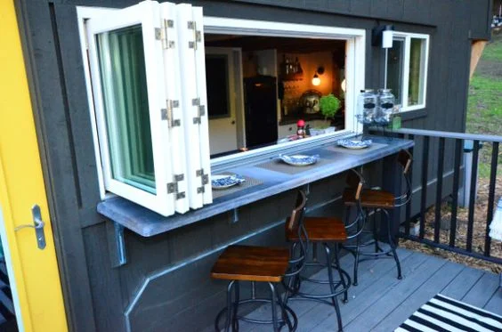 Pass-through window with bar on deck. Joshua and Shelly's tiny house