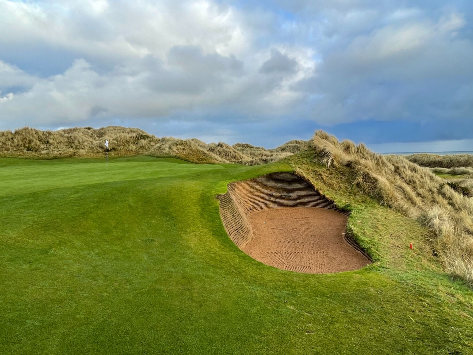 A deep bunker protects the par 3 6th