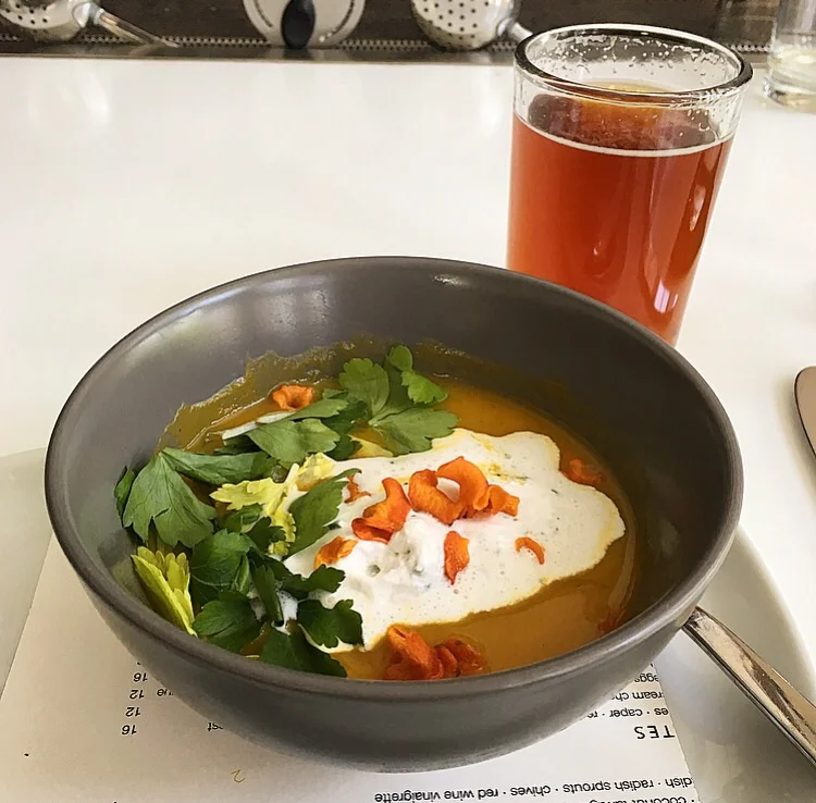 roasted carrot bisque with coconut tarragon cream and carrot chips with a locally brewed Thirsty Goat Amber Ale