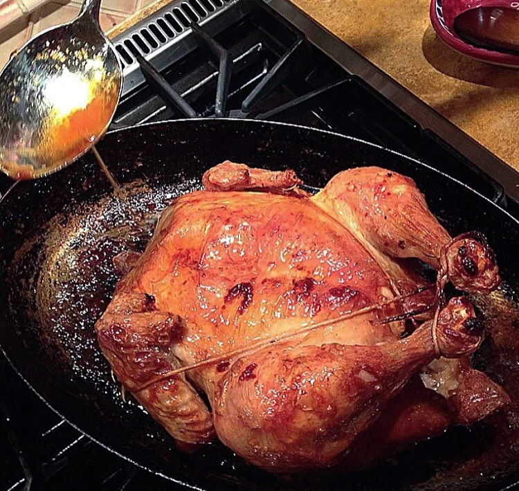 Basting the chicken helps to crisp the skin