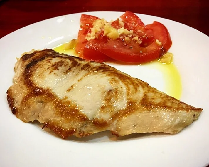 A bit of fish with garlicky, juicy tomatoes makes for a delicious snack in Jerez