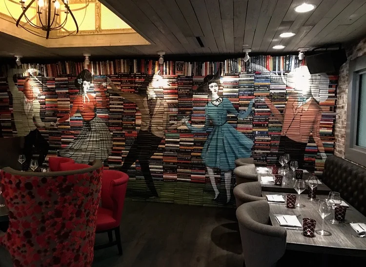One of the dining rooms at The Tuck Room. Those are real books that were painted on!