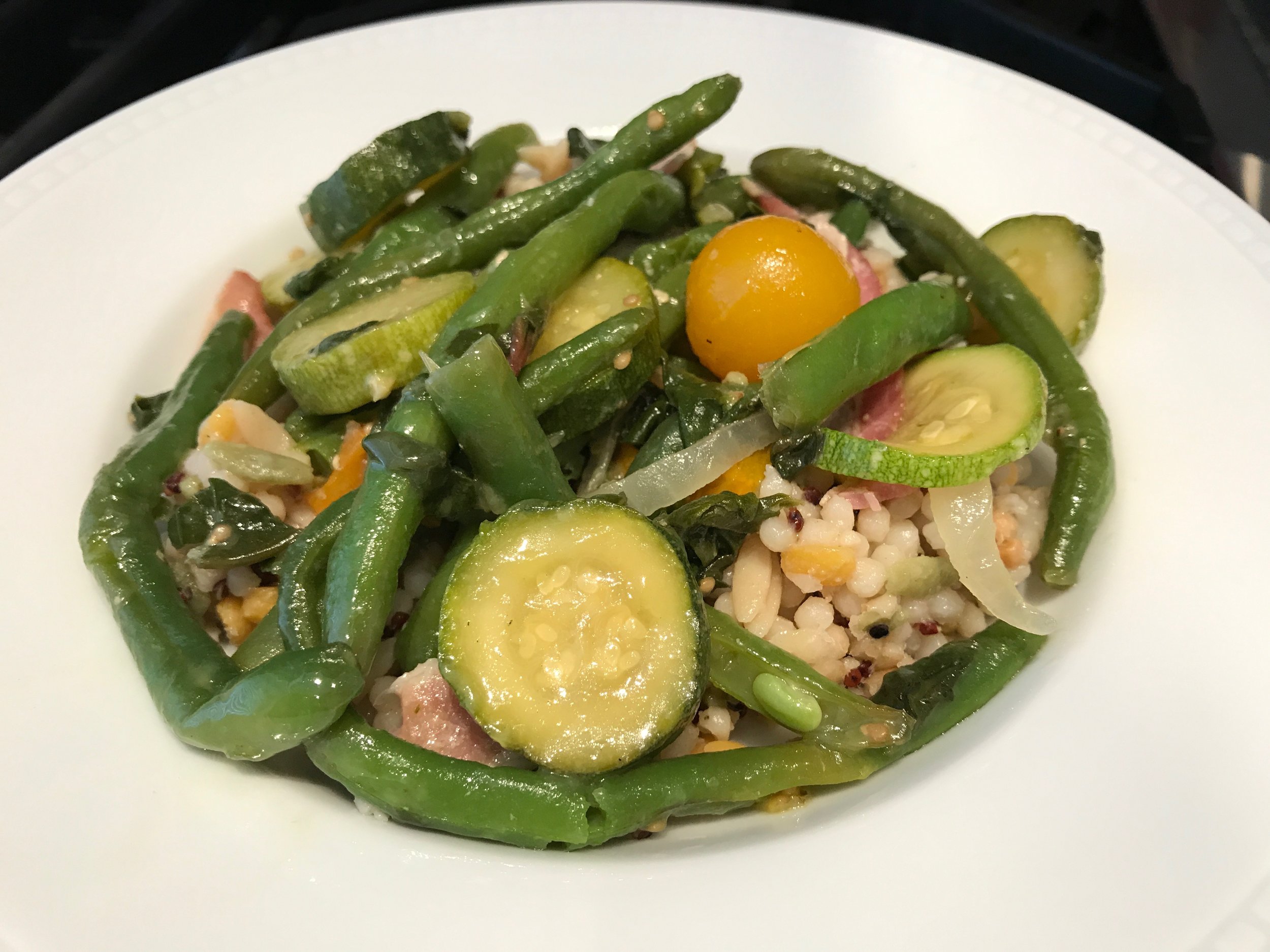 Here, the vegetables are served on top of Israeli cous cous.